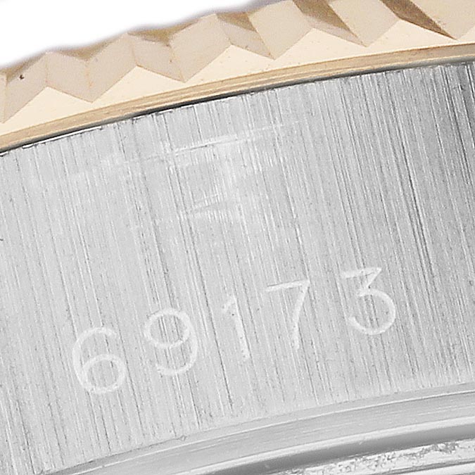 The image shows a close-up of the fluted bezel and case side with the Rolex Datejust 69173 Women
s Steel and Gold (two tone) White Dial 69173 Women
s Steel and Gold (two tone) White Dial model number engraved.