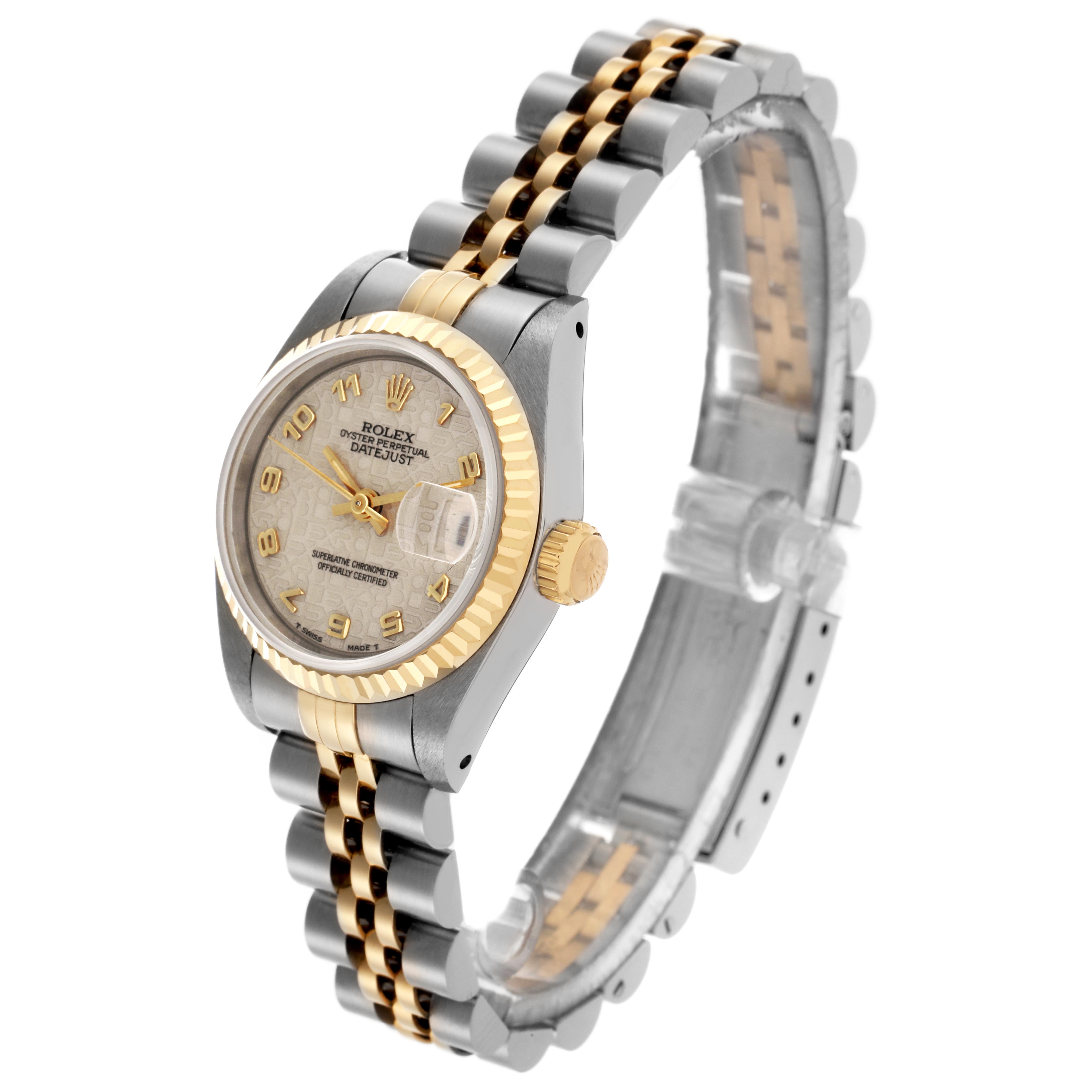 The Rolex Datejust 69173 Women
s Steel and Gold (two tone) White Dial 69173 Women
s Steel and Gold (two tone) White Dial watch is viewed from an angle showing the face, crown, and two-tone metal bracelet.