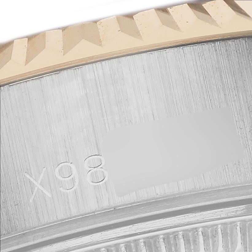 The image shows a close-up of the fluted bezel and part of the case of a Rolex Datejust 69173 Women
s Steel and Gold (two tone) White Dial 69173 Women
s Steel and Gold (two tone) White Dial watch.