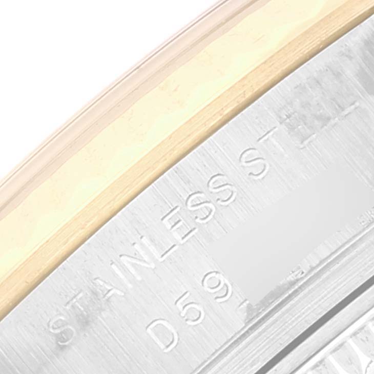 This image shows a close-up of the case edge and serial number of a Rolex Datejust 179173 Women's Steel and Gold (two tone) Blue Dial 179173 Women's Steel and Gold (two tone) Blue Dial watch, featuring the words "STAINLESS STEEL".