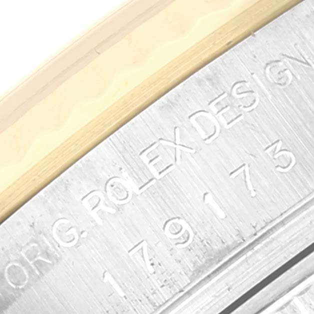 The image shows a close-up of the Rolex Datejust 179173 Women's Steel and Gold (two tone) Blue Dial 179173 Women's Steel and Gold (two tone) Blue Dial's engraved case side with the model number.