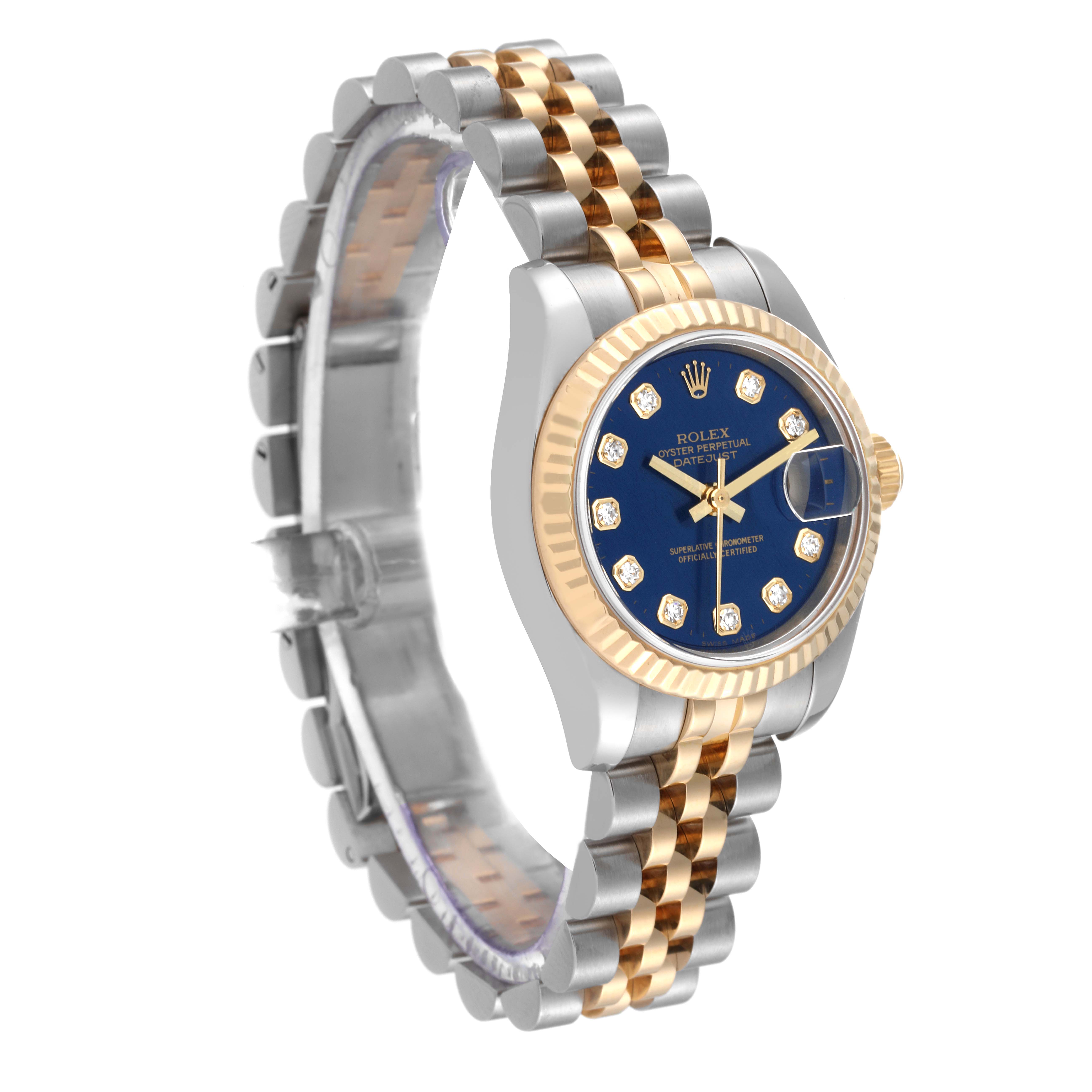 This Rolex Datejust 179173 Women's Steel and Gold (two tone) Blue Dial 179173 Women's Steel and Gold (two tone) Blue Dial watch is shown at a slight angle showcasing the two-tone bracelet, fluted bezel, and blue dial with diamond indices.