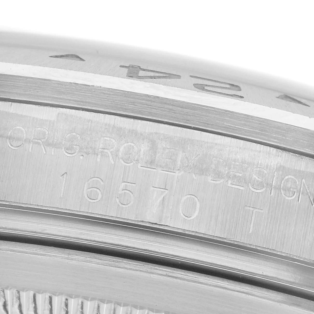 The image shows a close-up of the case side of a Rolex Explorer 16570 Men
s Stainless Steel Black Dial 16570 Men
s Stainless Steel Black Dial, highlighting the engraved model number "16570 T."