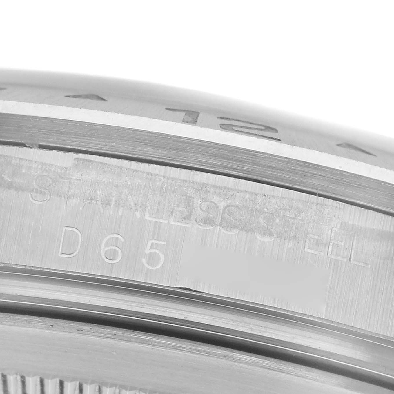 The image shows a close-up angle of the Rolex Explorer 16570 Men
s Stainless Steel Black Dial 16570 Men
s Stainless Steel Black Dial model, focusing on the bezel and engraved stainless steel details.