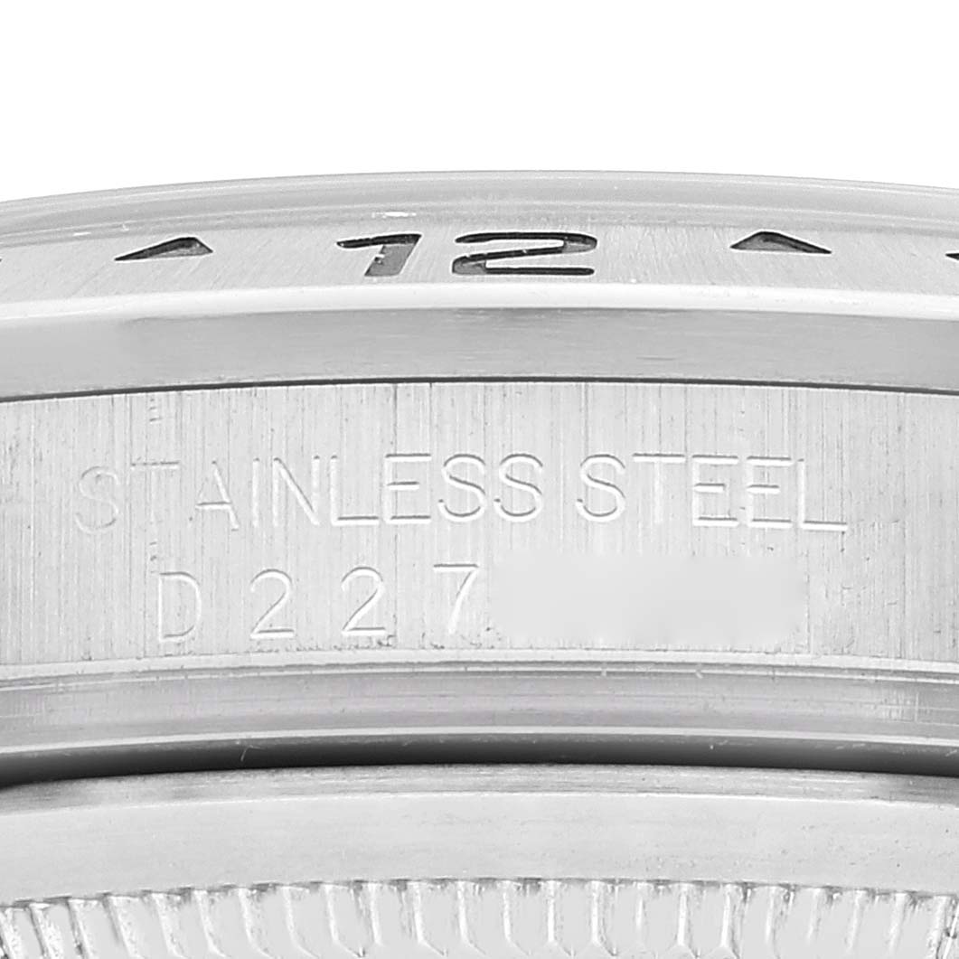 The image shows a close-up of the case back and part of the bezel of a Rolex Explorer 16570T Men
s Stainless Steel White Dial 16570T Men
s Stainless Steel White Dial watch.