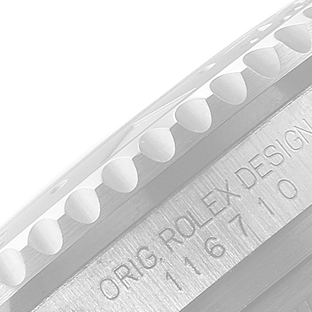 This image shows a close-up of the bezel and case side engraving "ORIG ROLEX DESIGN" of a Rolex GMT-Master 116710 Men's Stainless Steel Black Dial 116710 Men's Stainless Steel Black Dial watch.