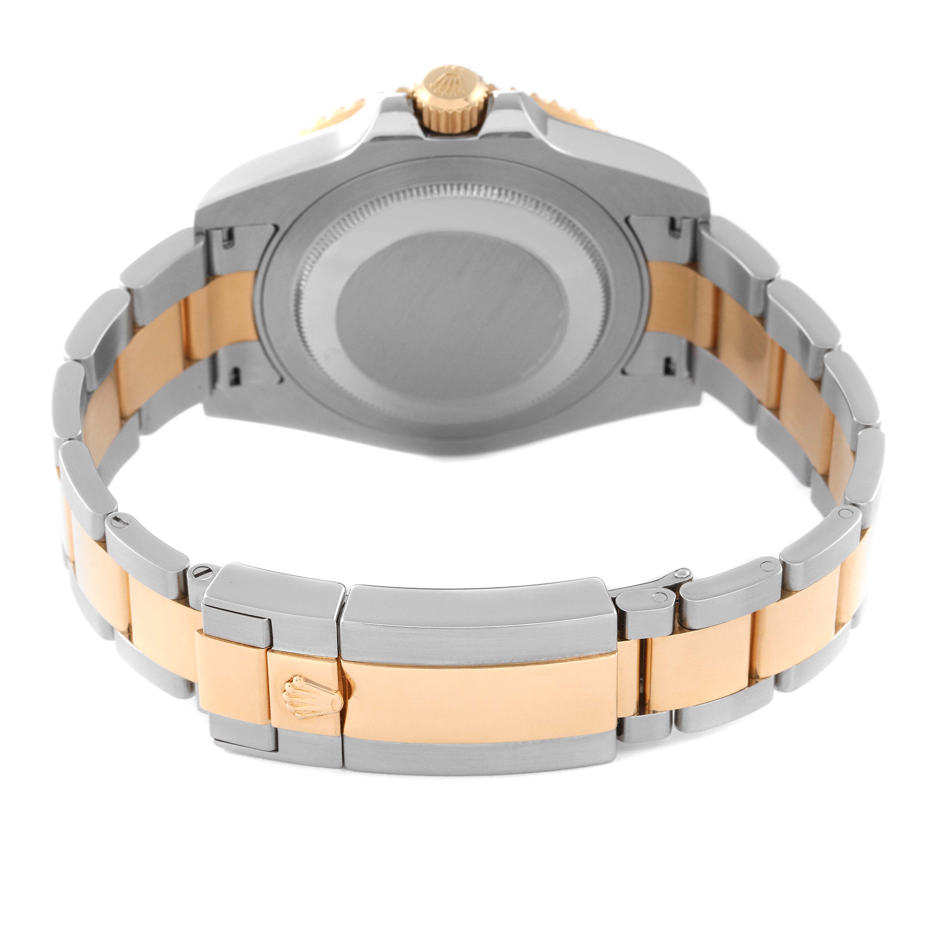 This image shows the backside view of a Rolex GMT-Master 116713 Men's Steel and Gold (two tone) Black Dial 116713 Men's Steel and Gold (two tone) Black Dial watch, highlighting its case, crown, and two-tone bracelet.