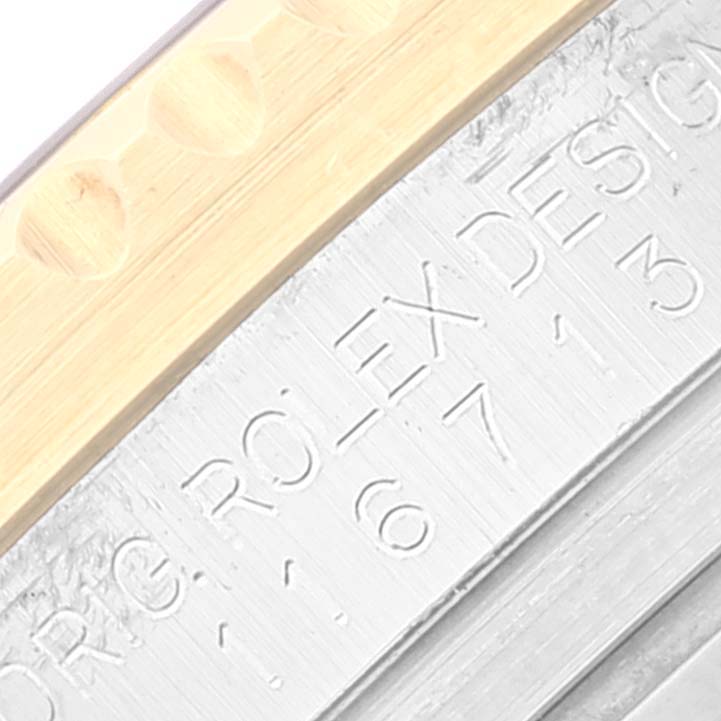 The image shows a close-up of the engraved inner bezel of a Rolex GMT-Master 116713 Men's Steel and Gold (two tone) Black Dial 116713 Men's Steel and Gold (two tone) Black Dial watch.