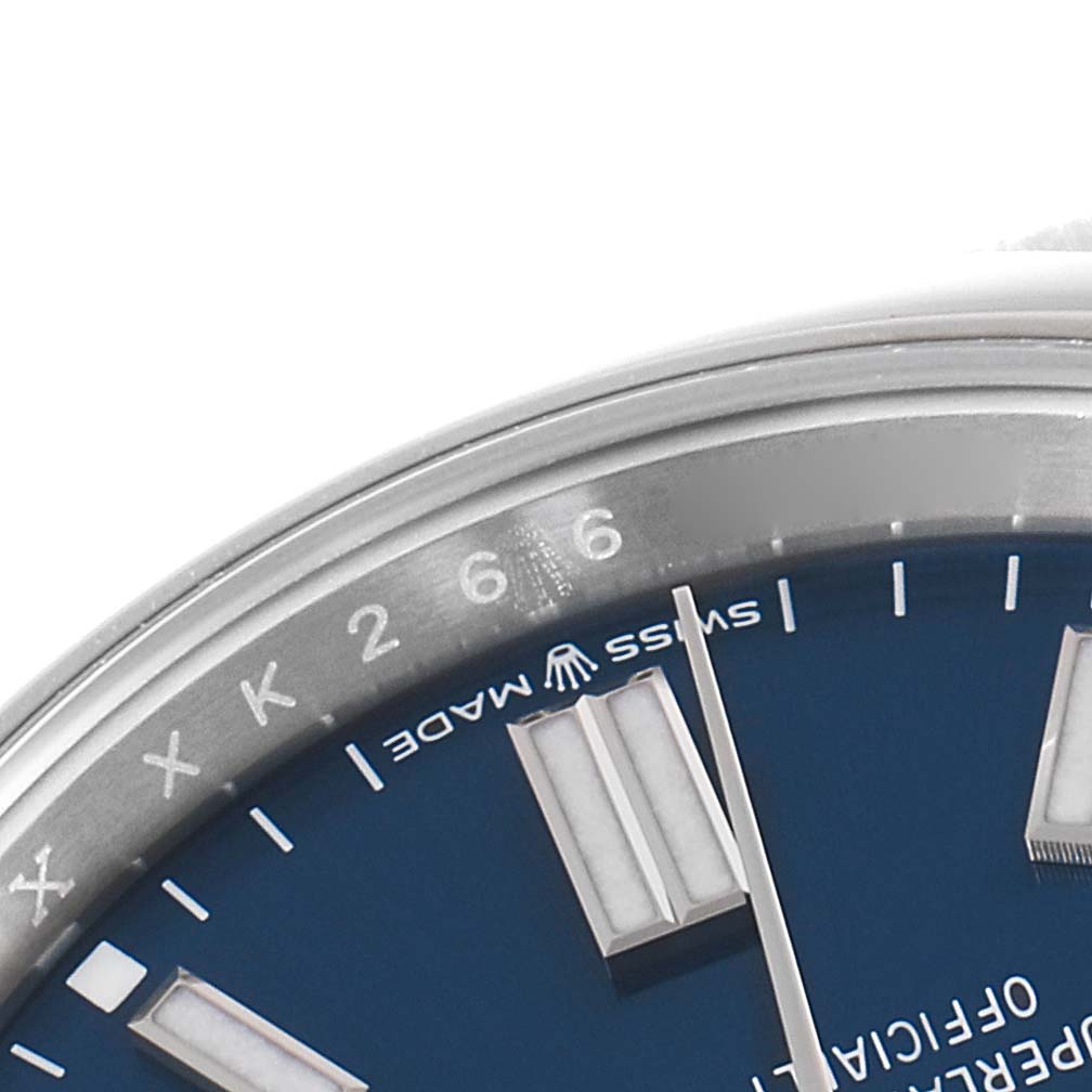 This image shows a close-up of the dial and bezel of a Rolex Oyster Perpetual 126000 Men's Stainless Steel Blue Dial 126000 Men's Stainless Steel Blue Dial watch.