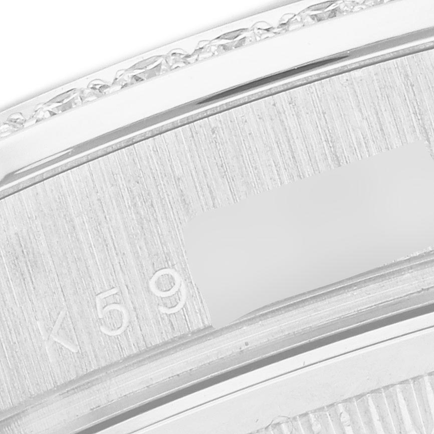 This close-up image shows part of the case back or bracelet of a Rolex President 118389 Men
s White Gold White Dial 118389 Men
s White Gold White Dial watch, highlighting the engraved details.