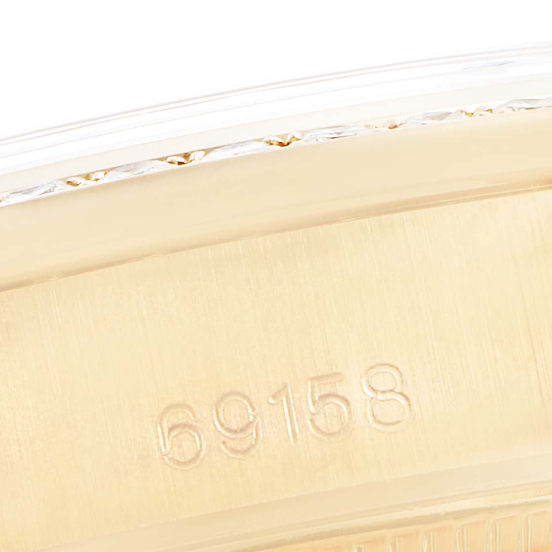 This close-up image of the Rolex President 69158 Women
s Yellow Gold Champagne Dial 69158 Women
s Yellow Gold Champagne Dial model shows the watch band and engraved serial number "69158."
