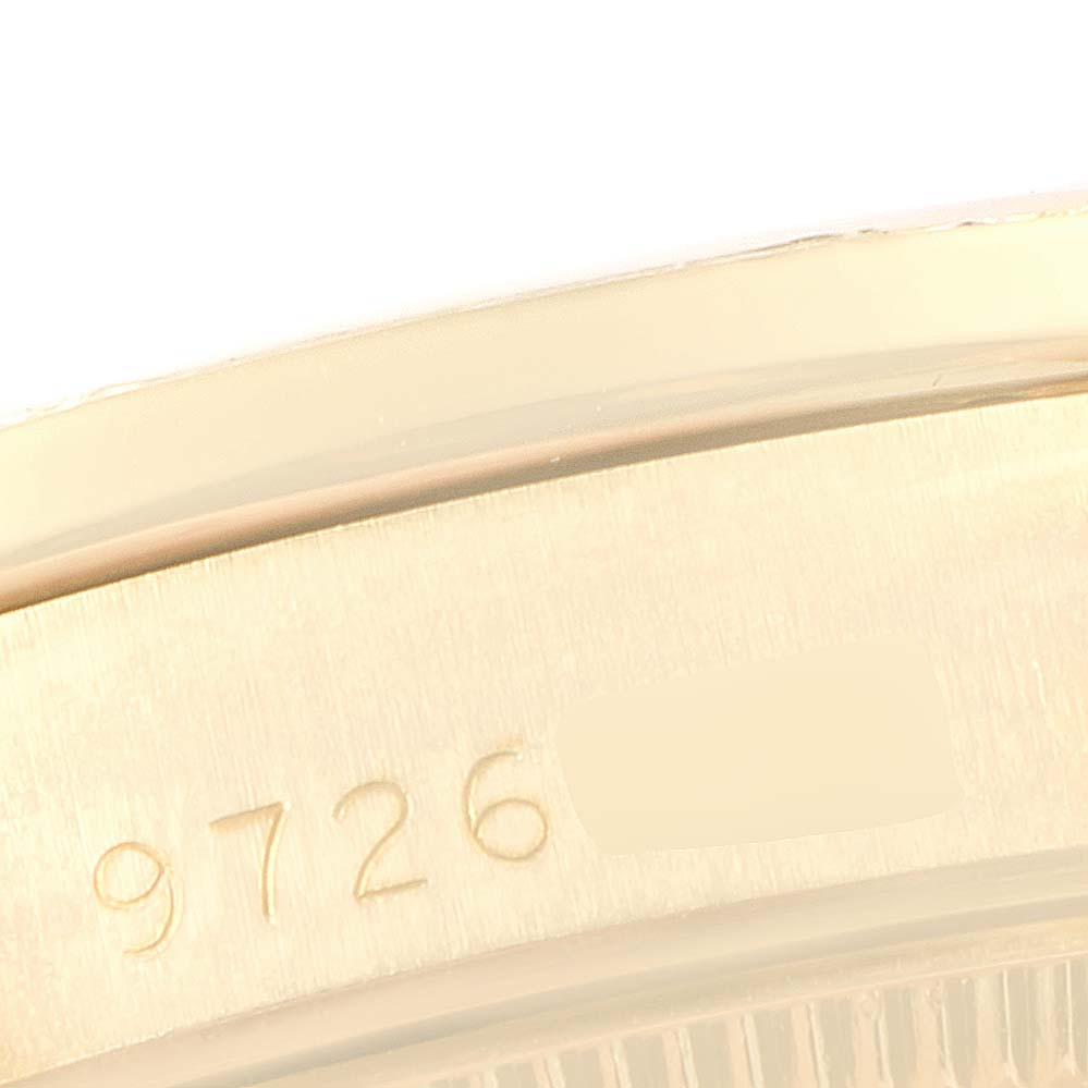 This is a close-up angle of the bezel or case of a Rolex President 69158 Women
s Yellow Gold Champagne Dial 69158 Women
s Yellow Gold Champagne Dial model, showing a partial serial number.