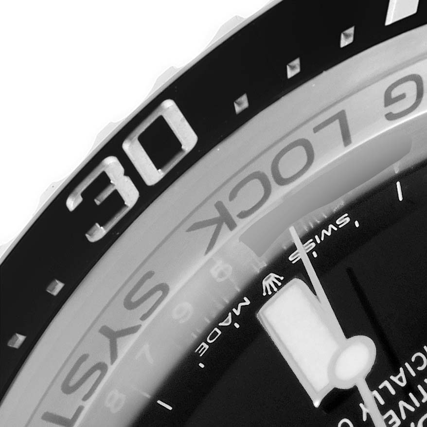 The image shows a close-up angle of the bezel and dial of a Rolex Sea-Dweller 126660 Men
s Stainless Steel Blue Dial 126660 Men
s Stainless Steel Blue Dial watch, with focus on the text and the "30" marker.