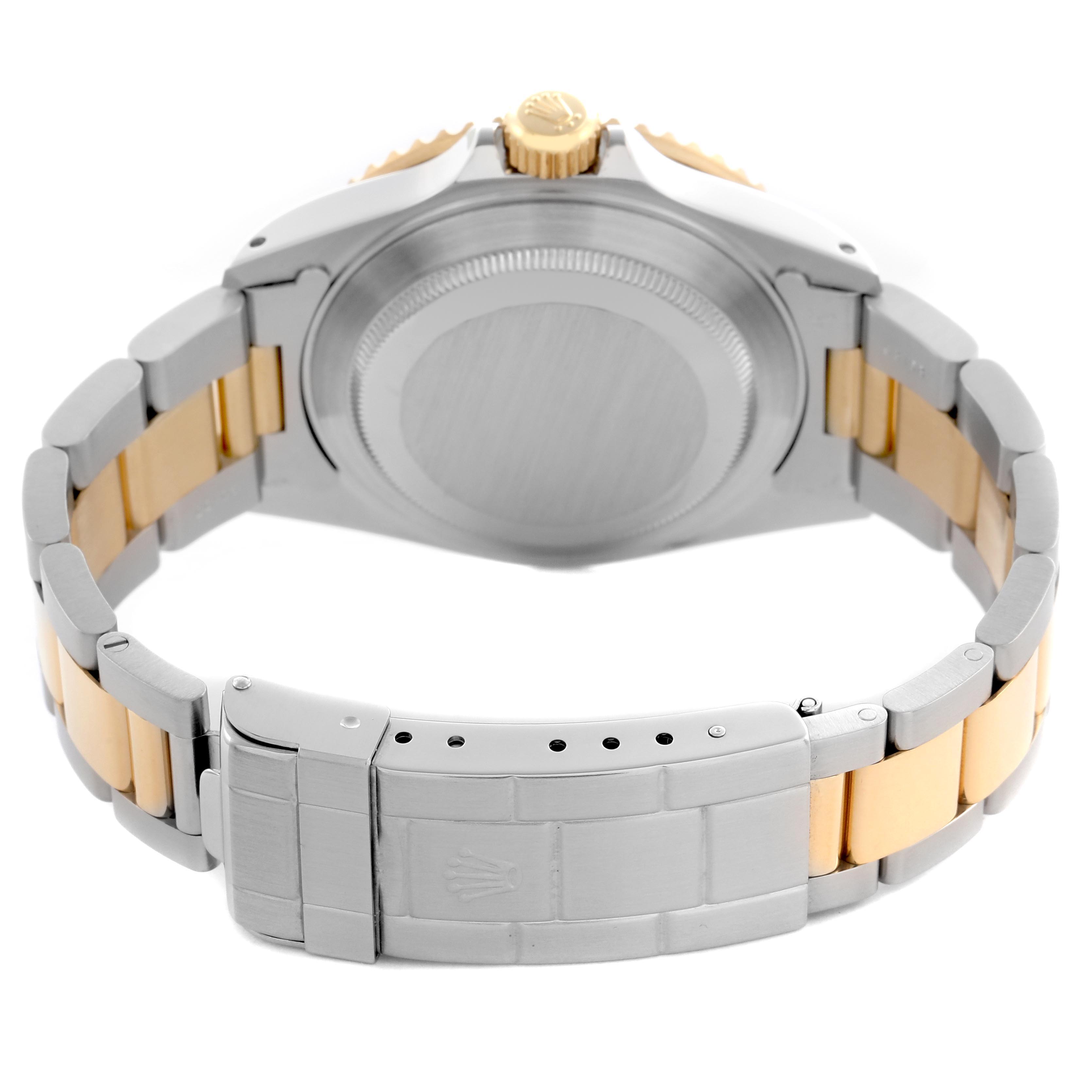 The image shows the rear view of a Rolex Submariner 16613 Men
s Steel and Gold (two tone) Champagne Dial 16613 Men
s Steel and Gold (two tone) Champagne Dial, highlighting the case back, crown, and two-tone bracelet.