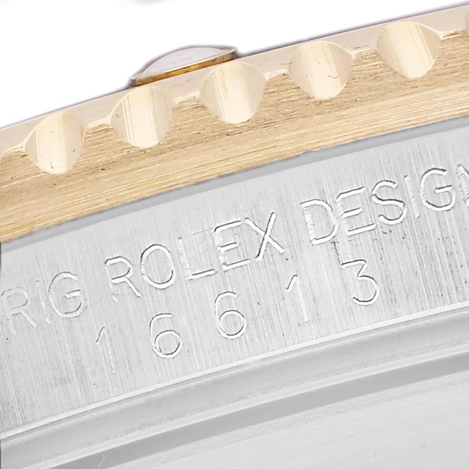 The image shows a close-up of the Rolex Submariner 16613 Men
s Steel and Gold (two tone) Champagne Dial 16613 Men
s Steel and Gold (two tone) Champagne Dial
s bezel and case side, highlighting the model number engraving.