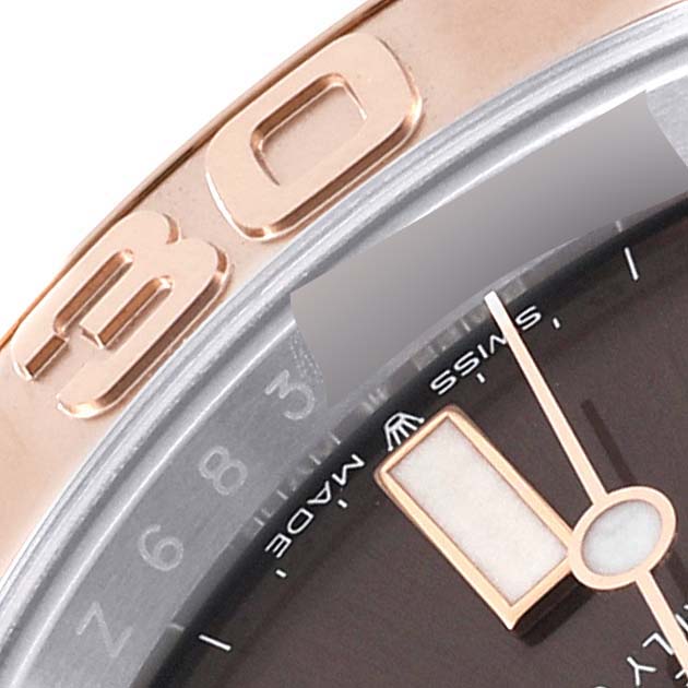 This image shows a close-up of the bezel and part of the dial of a Rolex Yacht-Master 126621 Men's Steel and Gold (two tone) Brown Dial 126621 Men's Steel and Gold (two tone) Brown Dial watch.