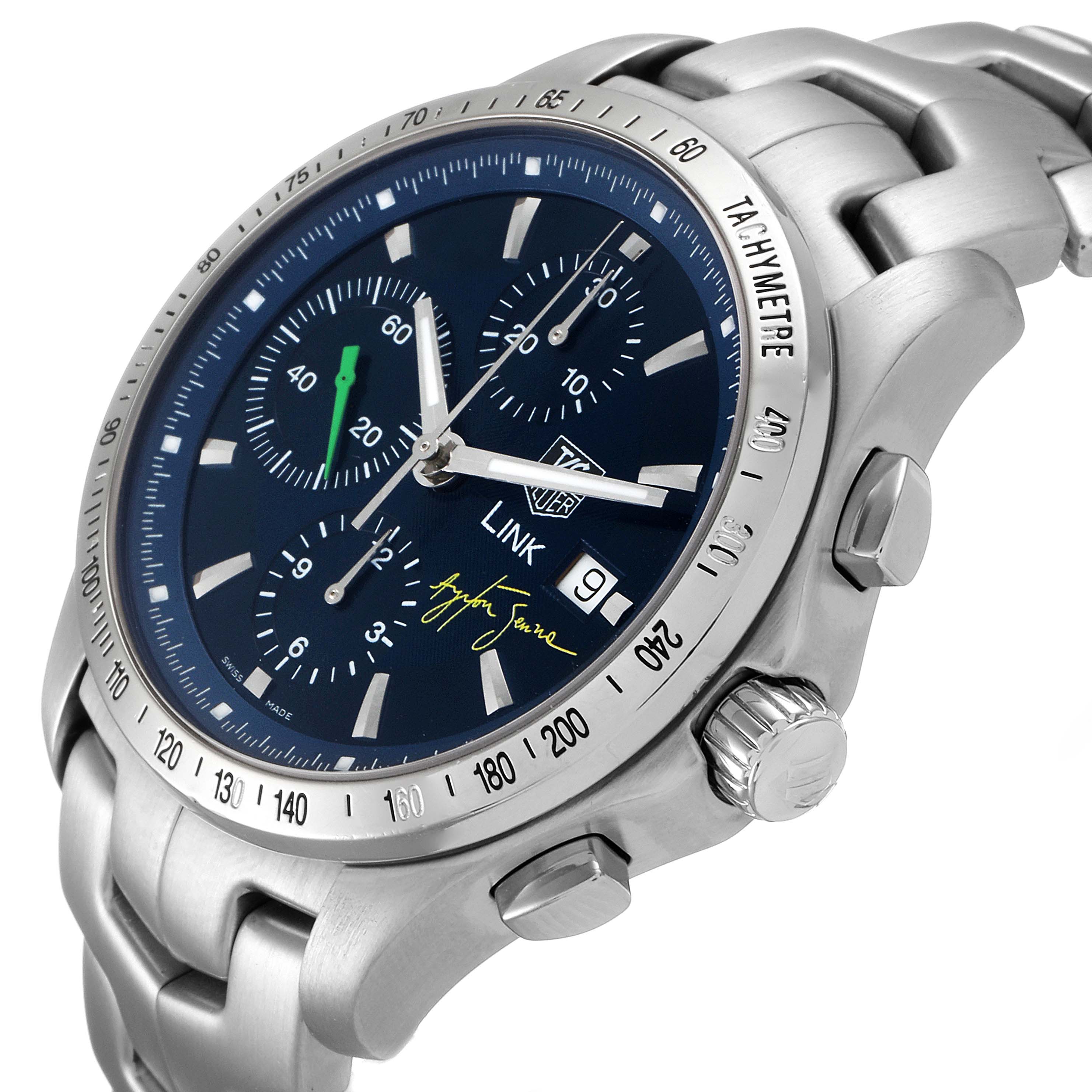 The Tag Heuer Link model watch is shown at a slight angle, highlighting the face, bezel, and part of the bracelet.