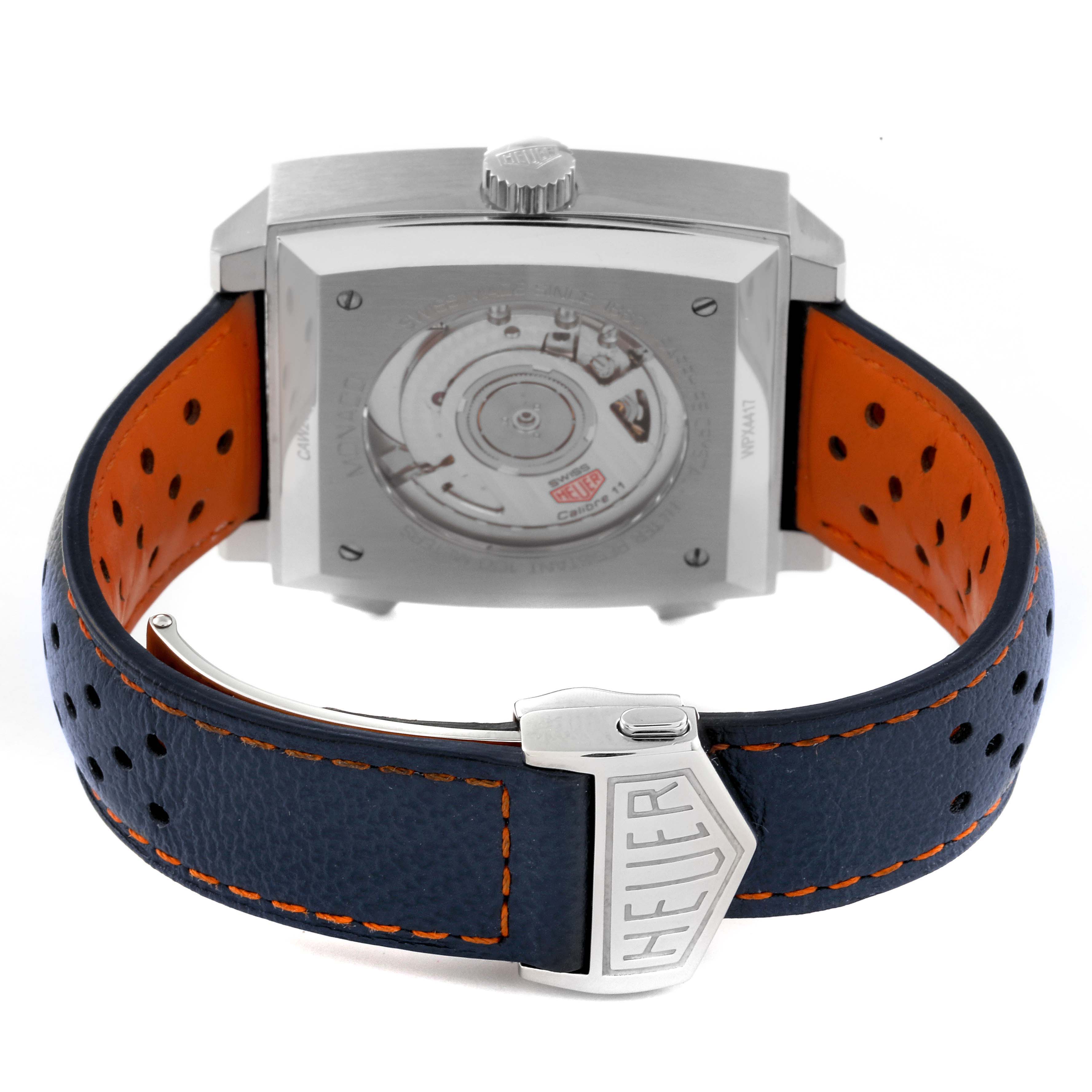 This image shows the back view of a Tag Heuer Monaco CAW211R.FC6401 Men's Stainless Steel Blue Dial CAW211R.FC6401 Men's Stainless Steel Blue Dial watch, highlighting its case back mechanisms and partially the leather strap.