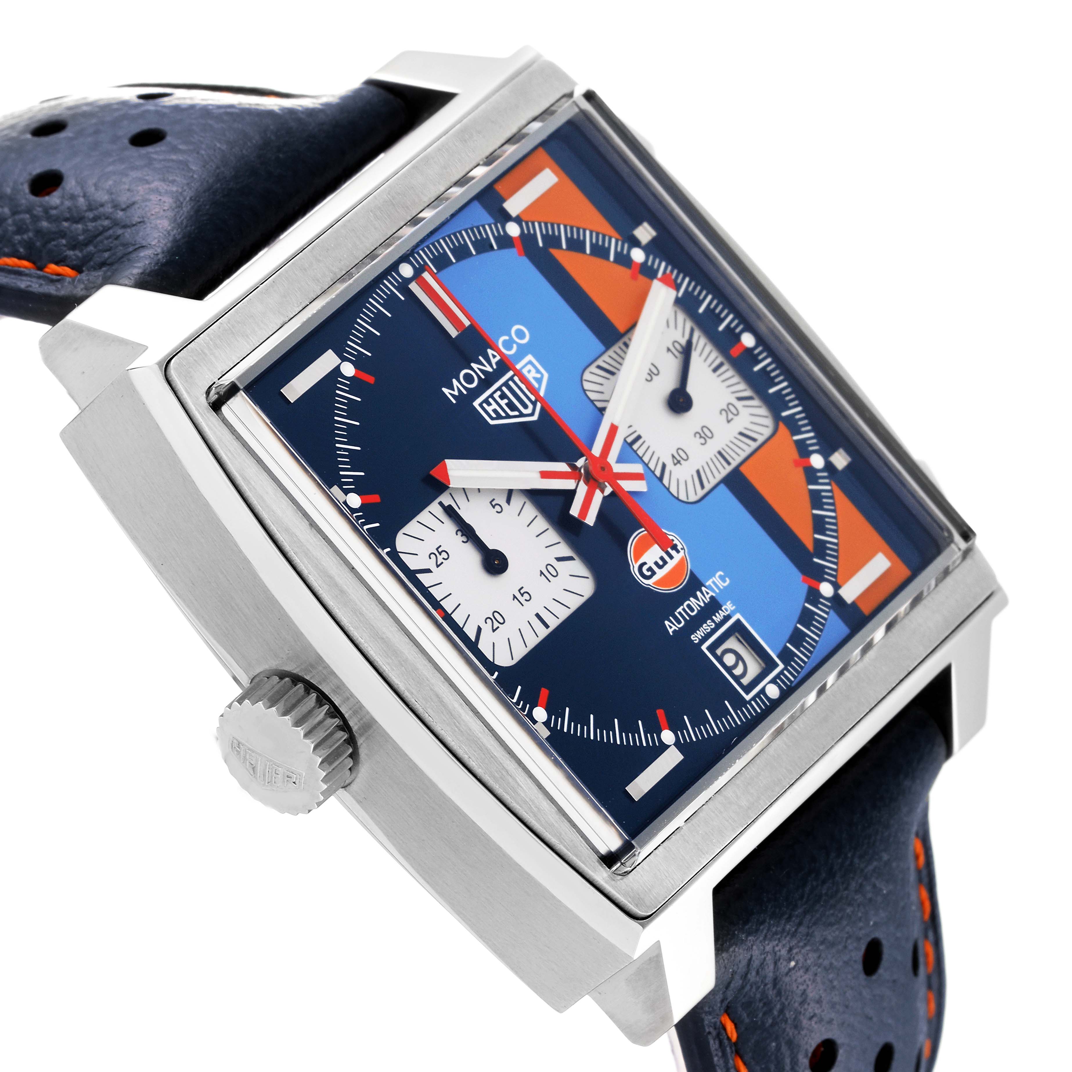 The image shows a slanted view of the Tag Heuer Monaco CAW211R.FC6401 Men's Stainless Steel Blue Dial CAW211R.FC6401 Men's Stainless Steel Blue Dial watch face, highlighting the bezel, crown, and part of the strap.