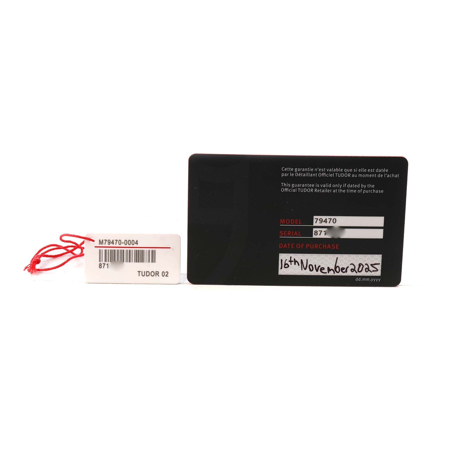 The image shows a warranty card and a tag for the Tudor Heritage Black Bay M79470-0004 Men's Stainless Steel White Dial model, displaying model and serial information.