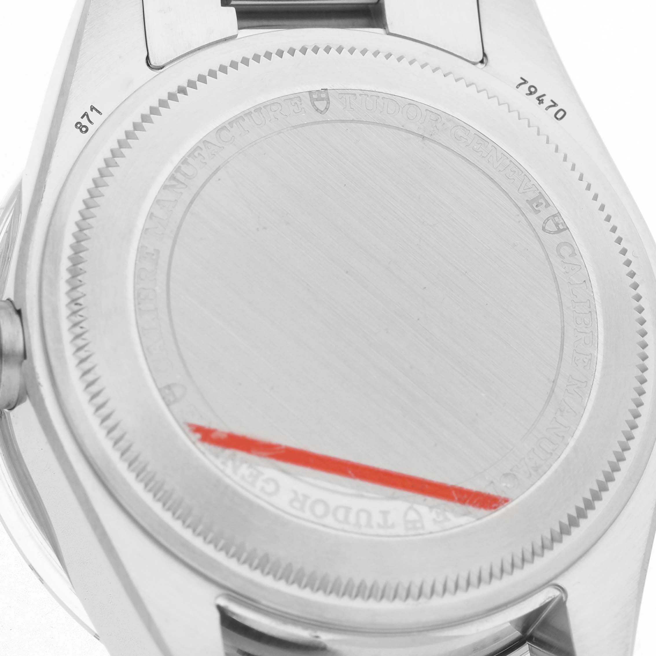 The image shows the case back of a Tudor Heritage Black Bay M79470-0004 Men's Stainless Steel White Dial watch, highlighting the engravings and edge details.