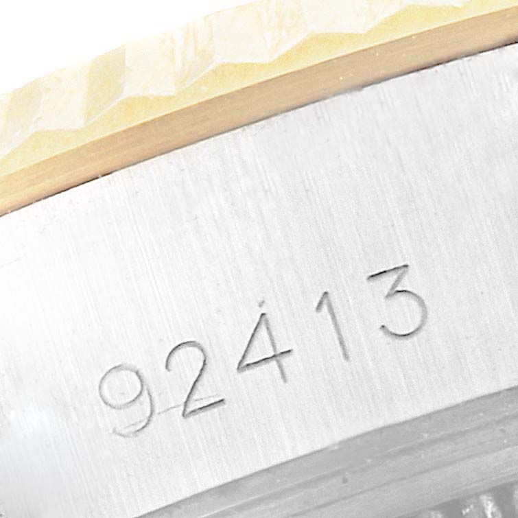 This image shows a close-up of the Tudor Princess 92413 Women's Steel and Gold (two tone) Champagne Dial 92413 Women's Steel and Gold (two tone) Champagne Dial model watch's bezel and engraved case serial number.