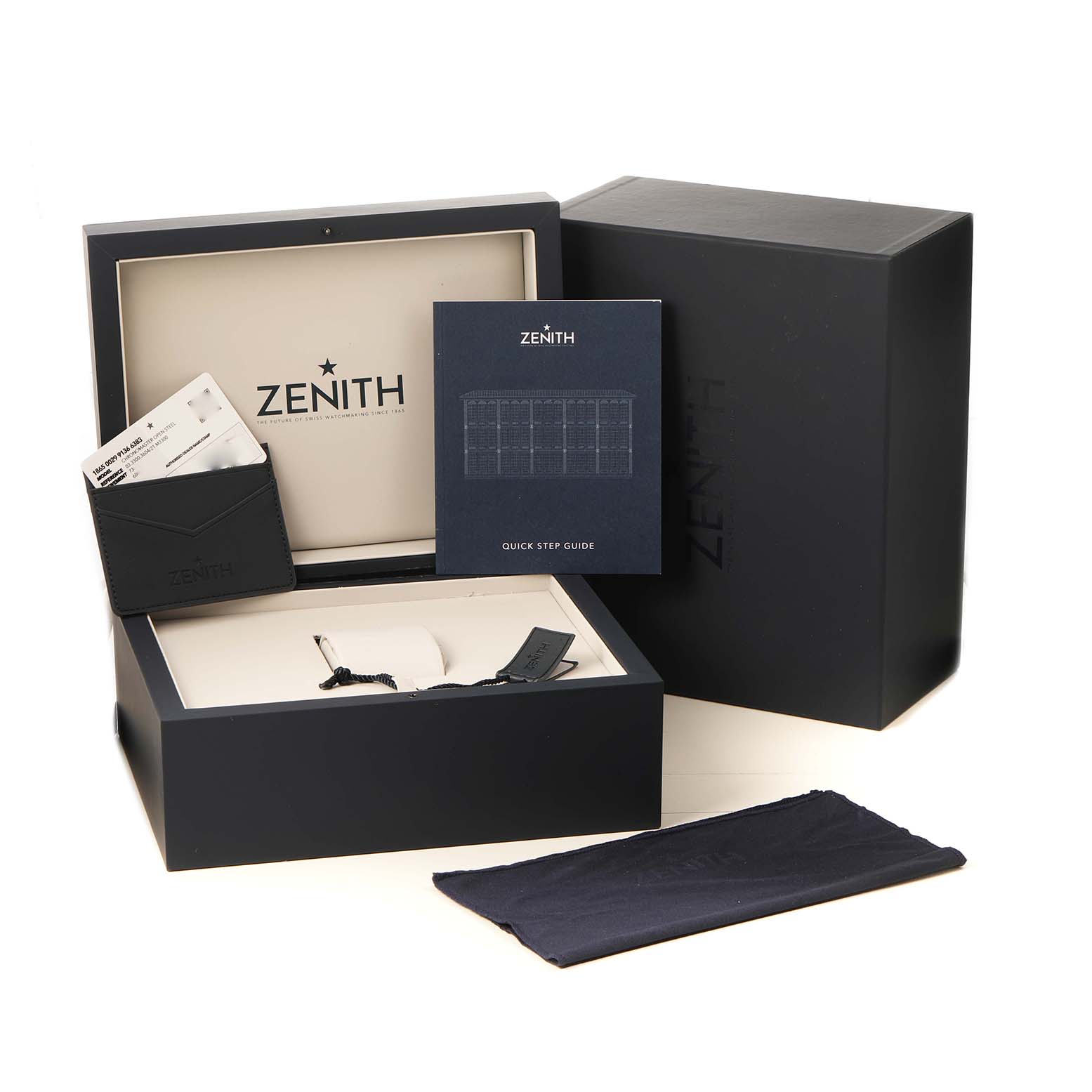 The image shows the Zenith Chronomaster 03.3300.3604 / 21.M3300 Men's Stainless Steel Black Dial watch packaging, including the inner box, documents, and accessories from a front angle.