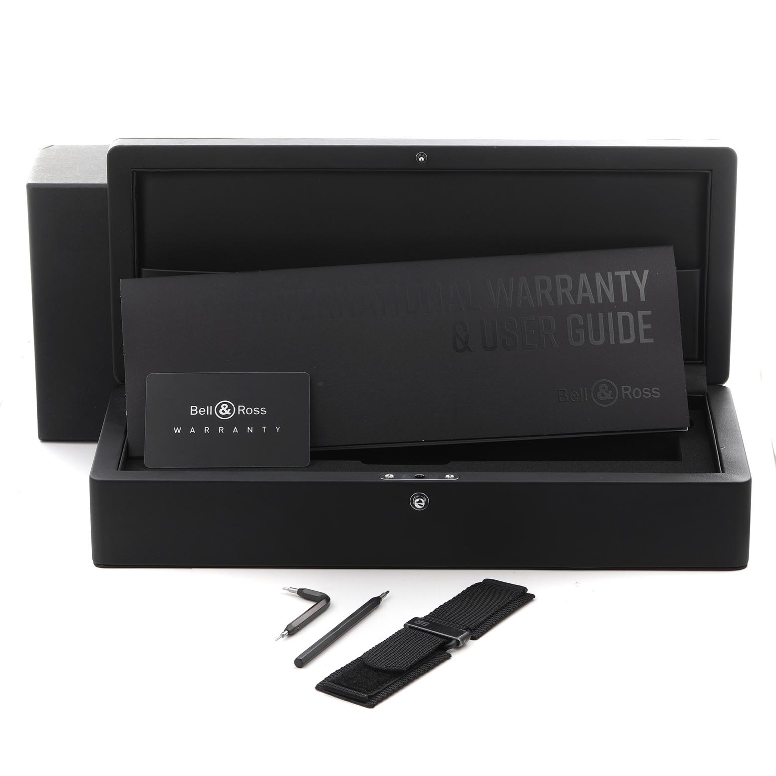 The image shows a Bell & Ross Instruments BR03-92-A522 Men's Ceramic Black Dial BR03-92-A522 Men's Ceramic Black Dial watch box with a warranty card, user guide, tools, and an additional strap.