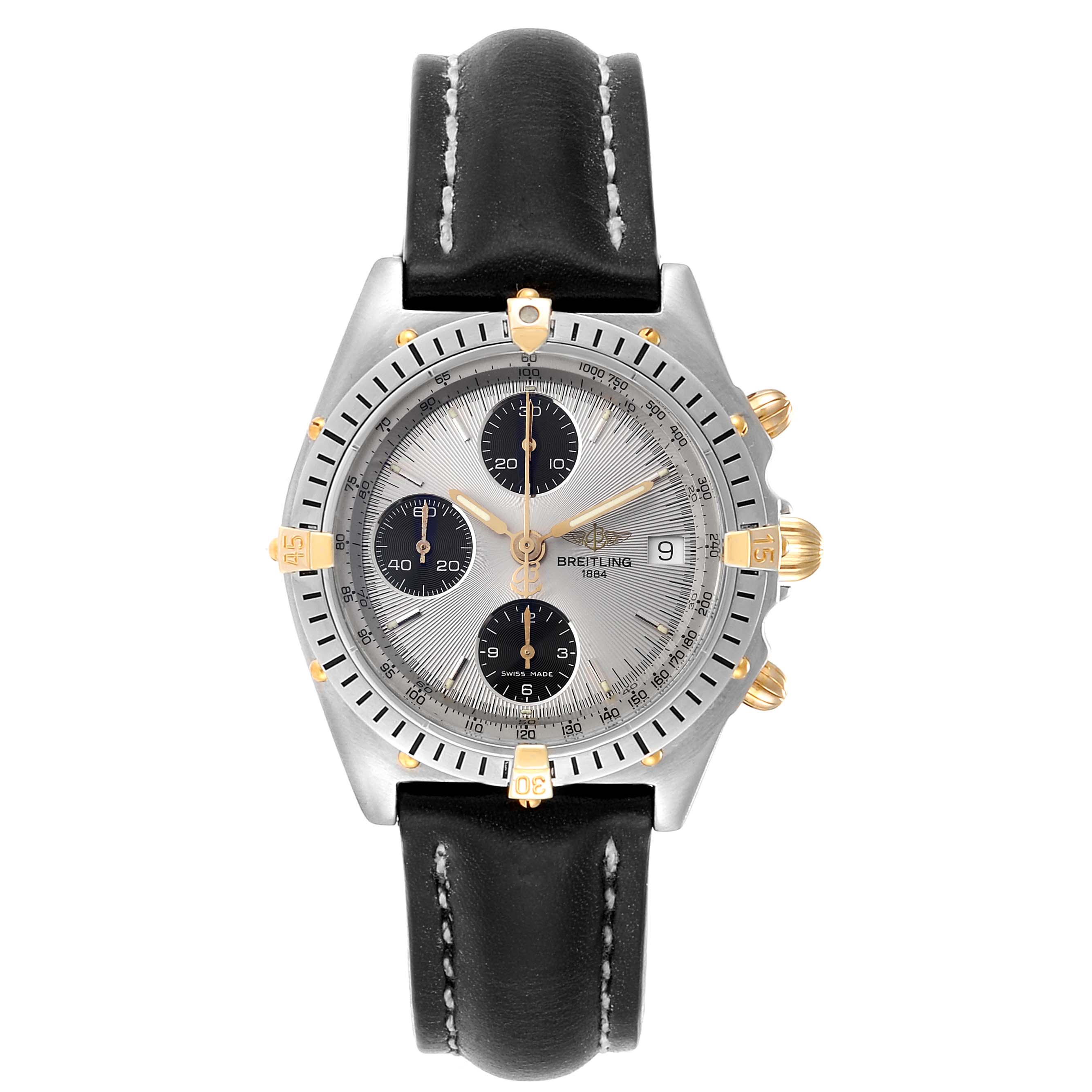 The image shows a front view of a Breitling Chronomat B13050 Men's Steel and Gold (two tone) Silver Dial B13050 Men's Steel and Gold (two tone) Silver Dial watch with a black leather strap and a silver dial with gold accents.
