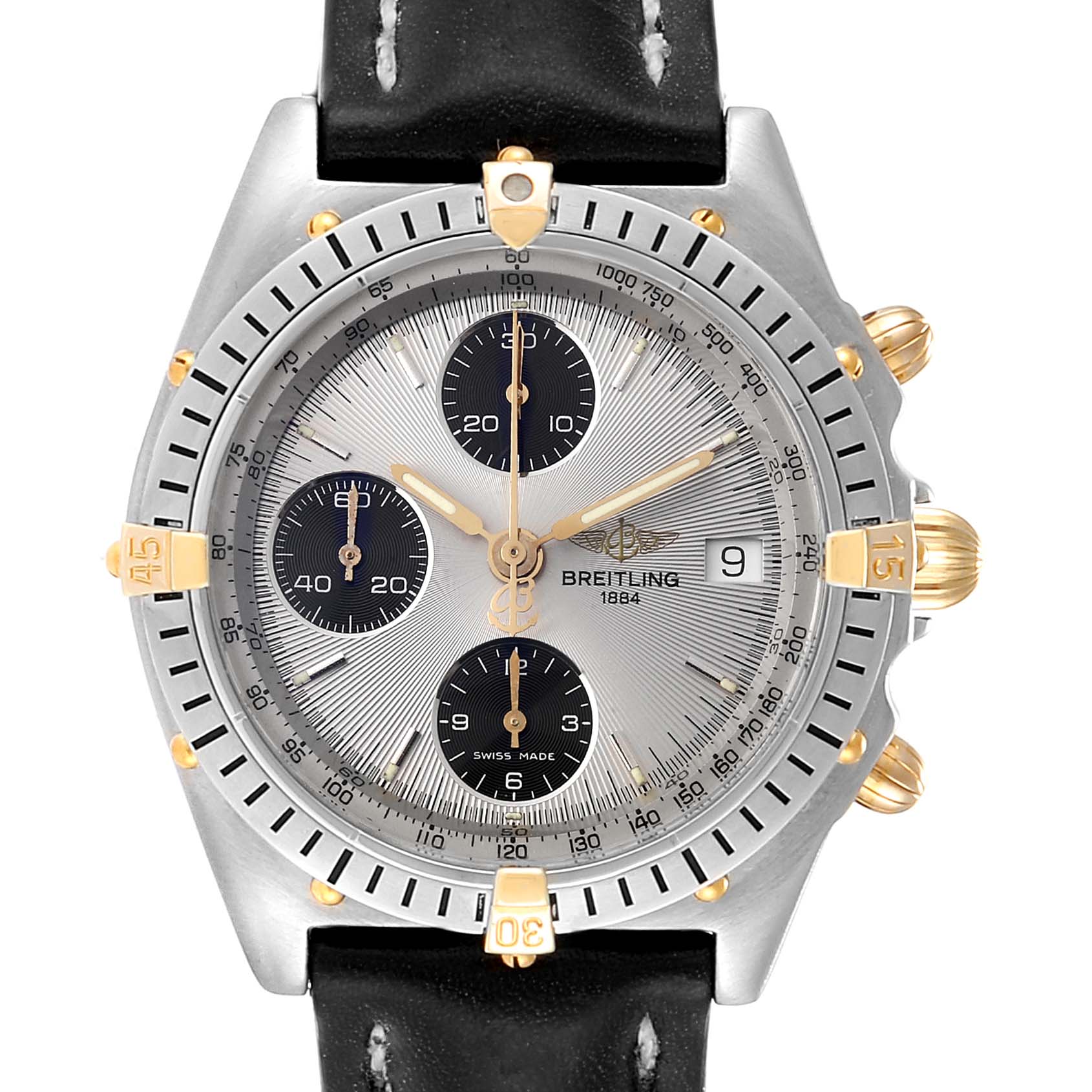 The image shows a front view of the Breitling Chronomat B13050 Men's Steel and Gold (two tone) Silver Dial B13050 Men's Steel and Gold (two tone) Silver Dial watch, displaying its dial, bezel, subdials, and part of the leather strap.