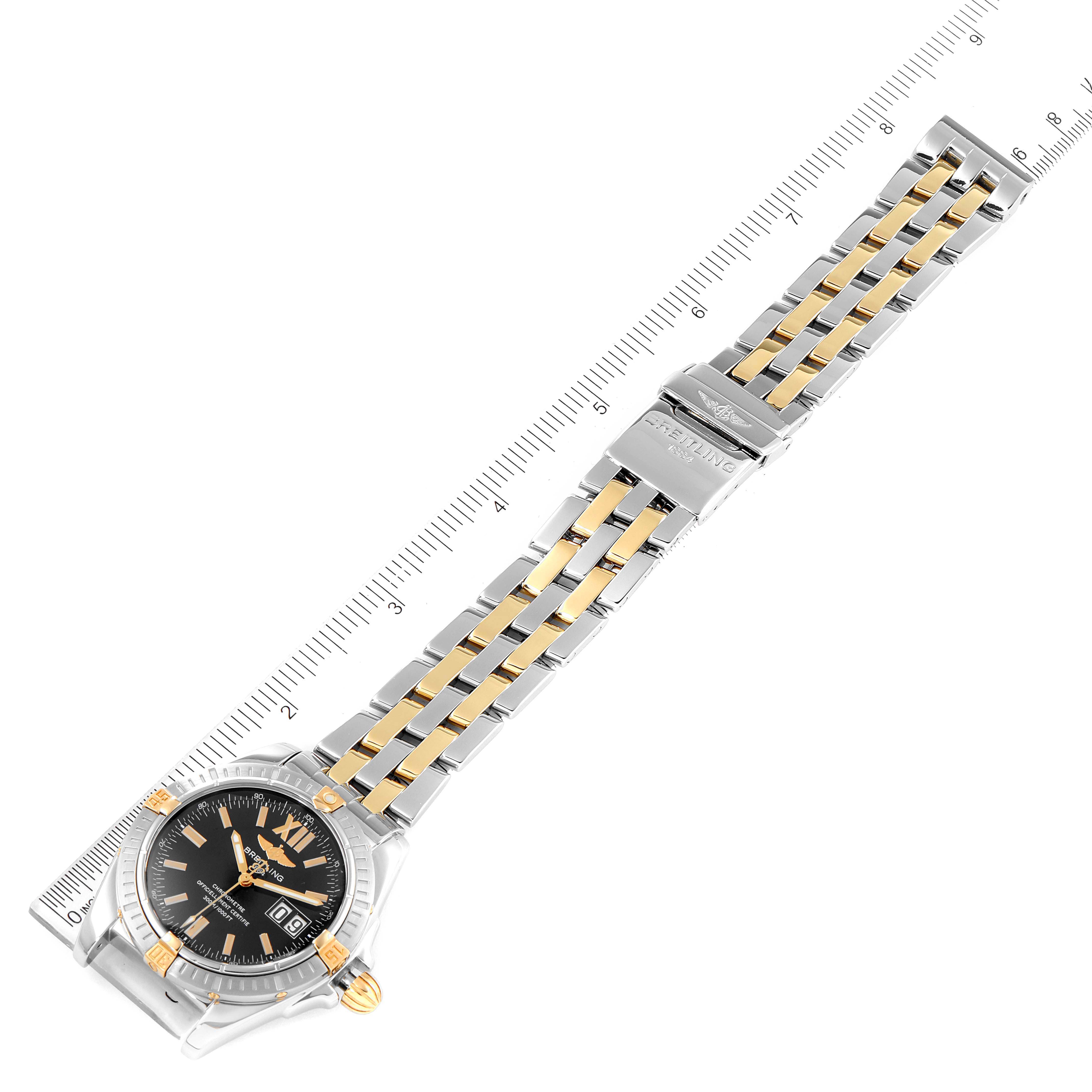 The image shows a top view of the Breitling Windrider B49350 Men's Steel and Gold (two tone) Black Dial B49350 Men's Steel and Gold (two tone) Black Dial watch displaying its face, bezel, and two-tone metal bracelet.