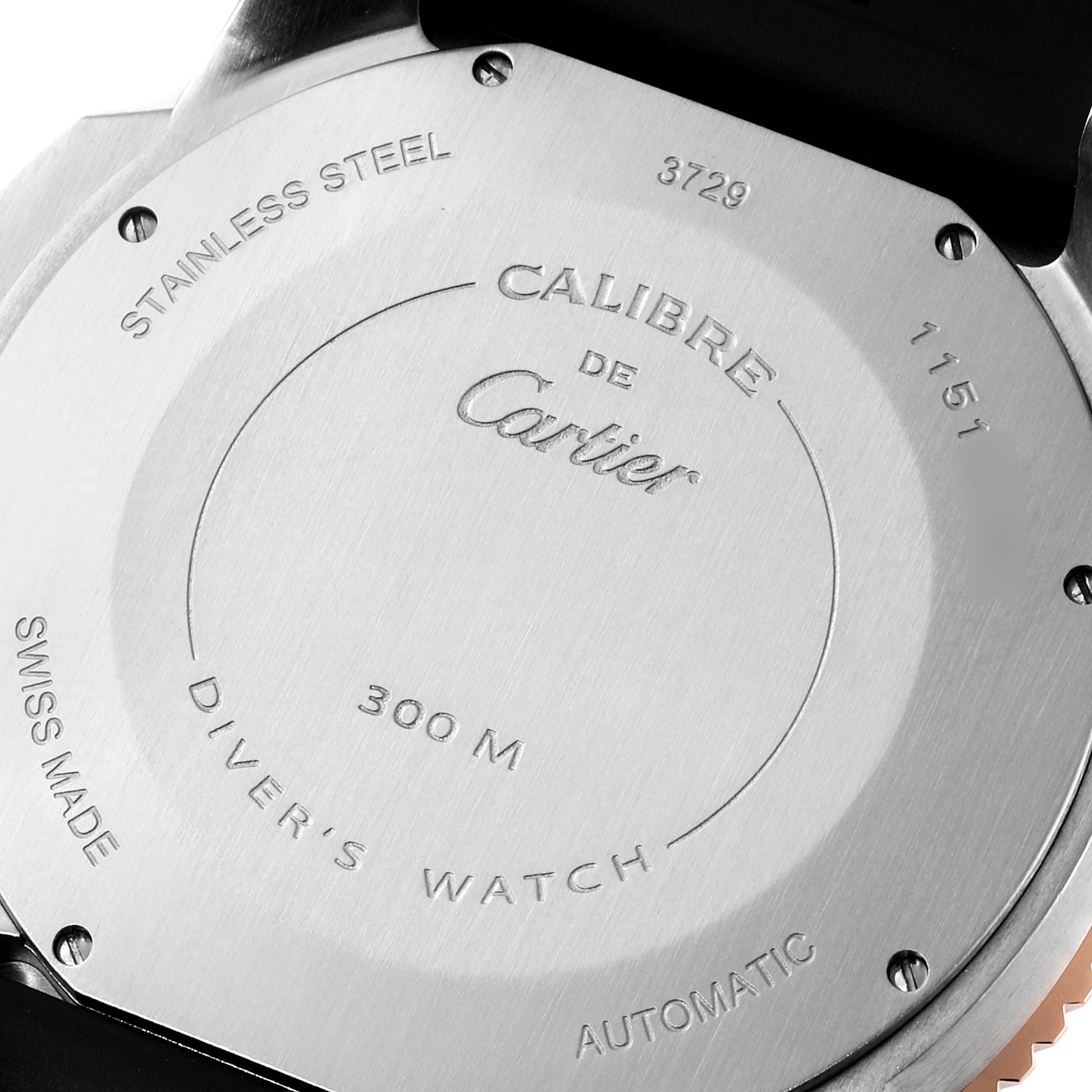 The image shows the back case of a Calibre de Cartier watch by Cartier, highlighting its engravings and specifications.
