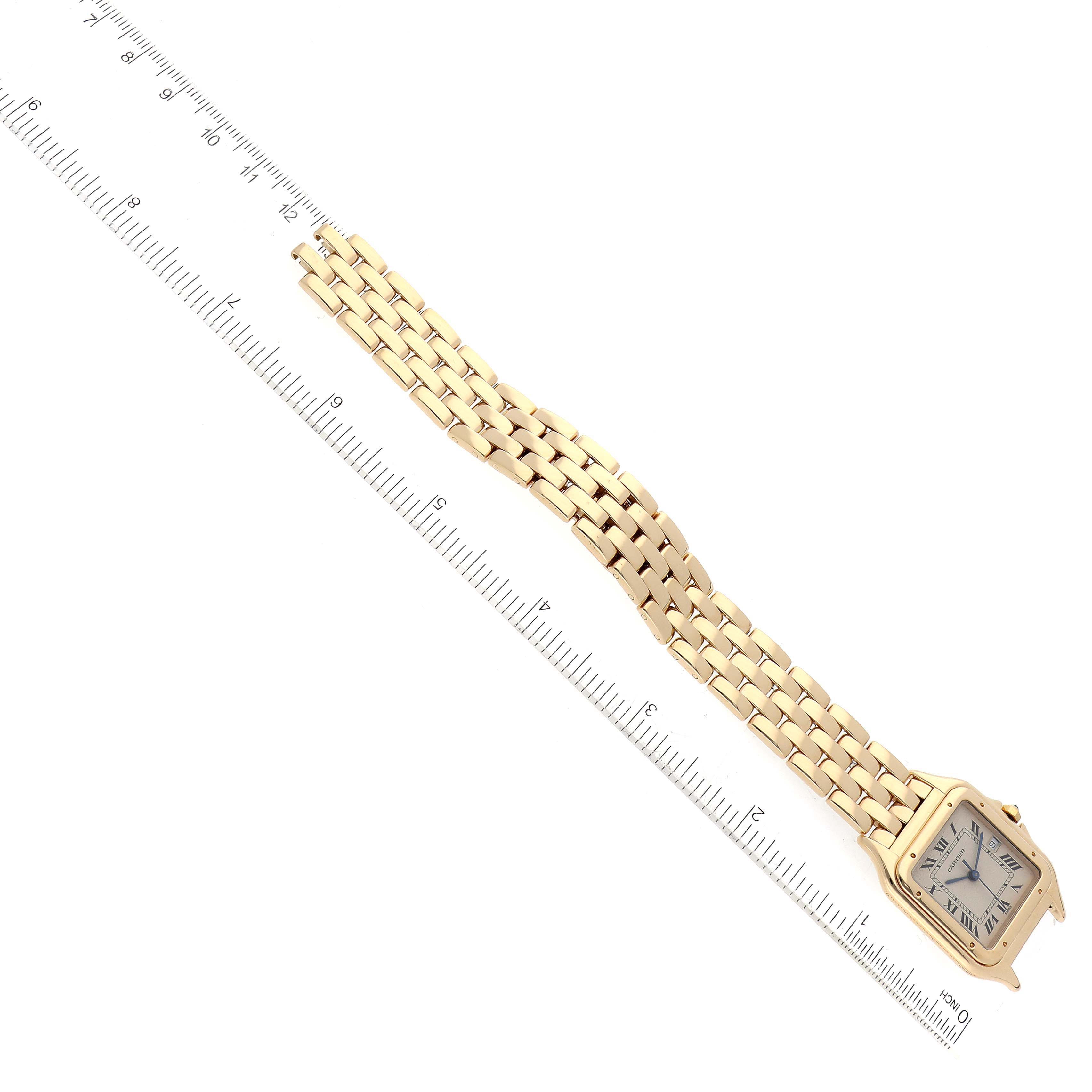 The image shows a gold Cartier Panthere W25014B9 Men's Yellow Gold Silver Dial W25014B9 Men's Yellow Gold Silver Dial watch at an angled view, alongside a ruler for scale.