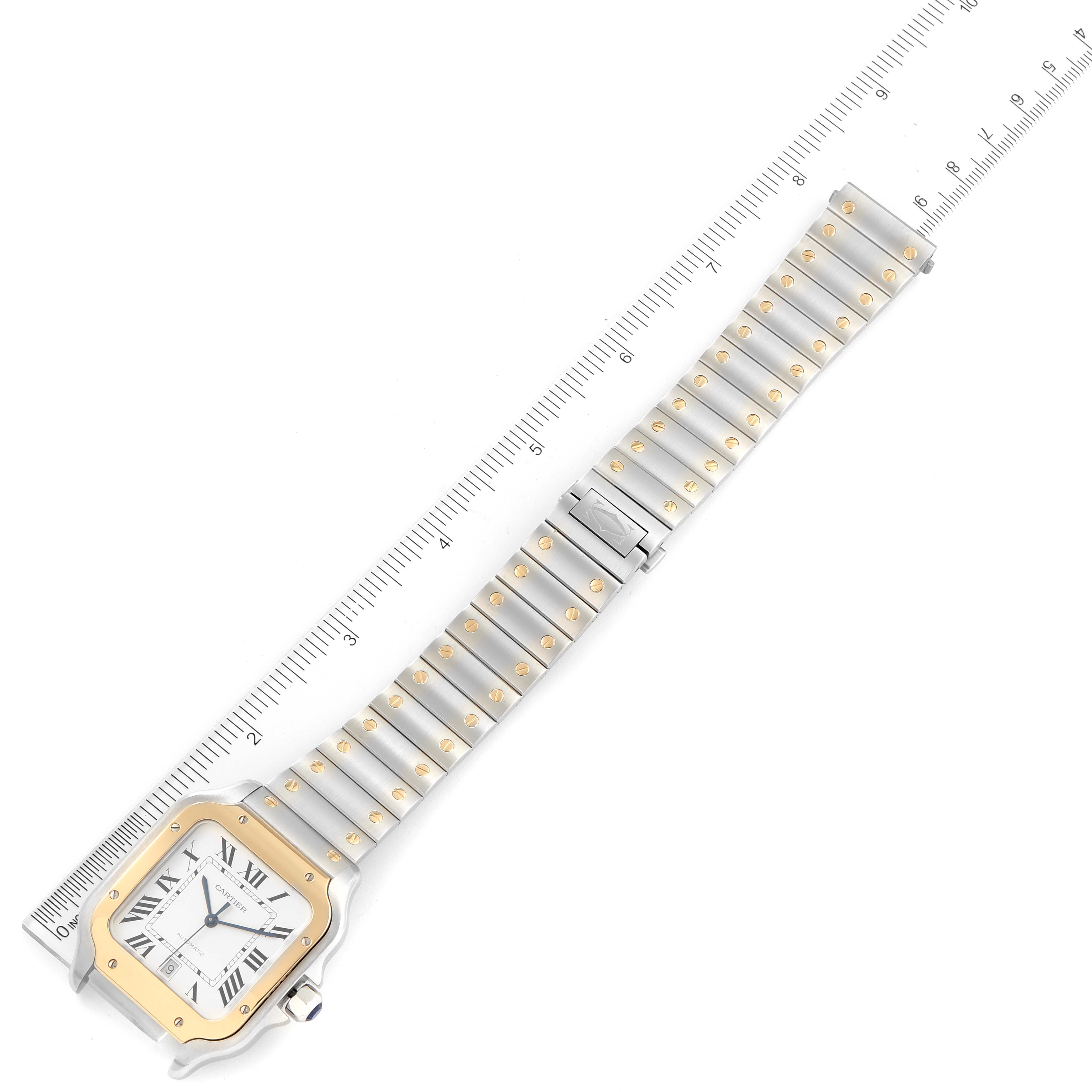 The image shows a top-down view of a Cartier Santos W2SA0009 Men
s Steel and Gold (two tone) Silver Dial W2SA0009 Men
s Steel and Gold (two tone) Silver Dial watch, highlighting the face, bezel, and full metal bracelet with ruler measurement.