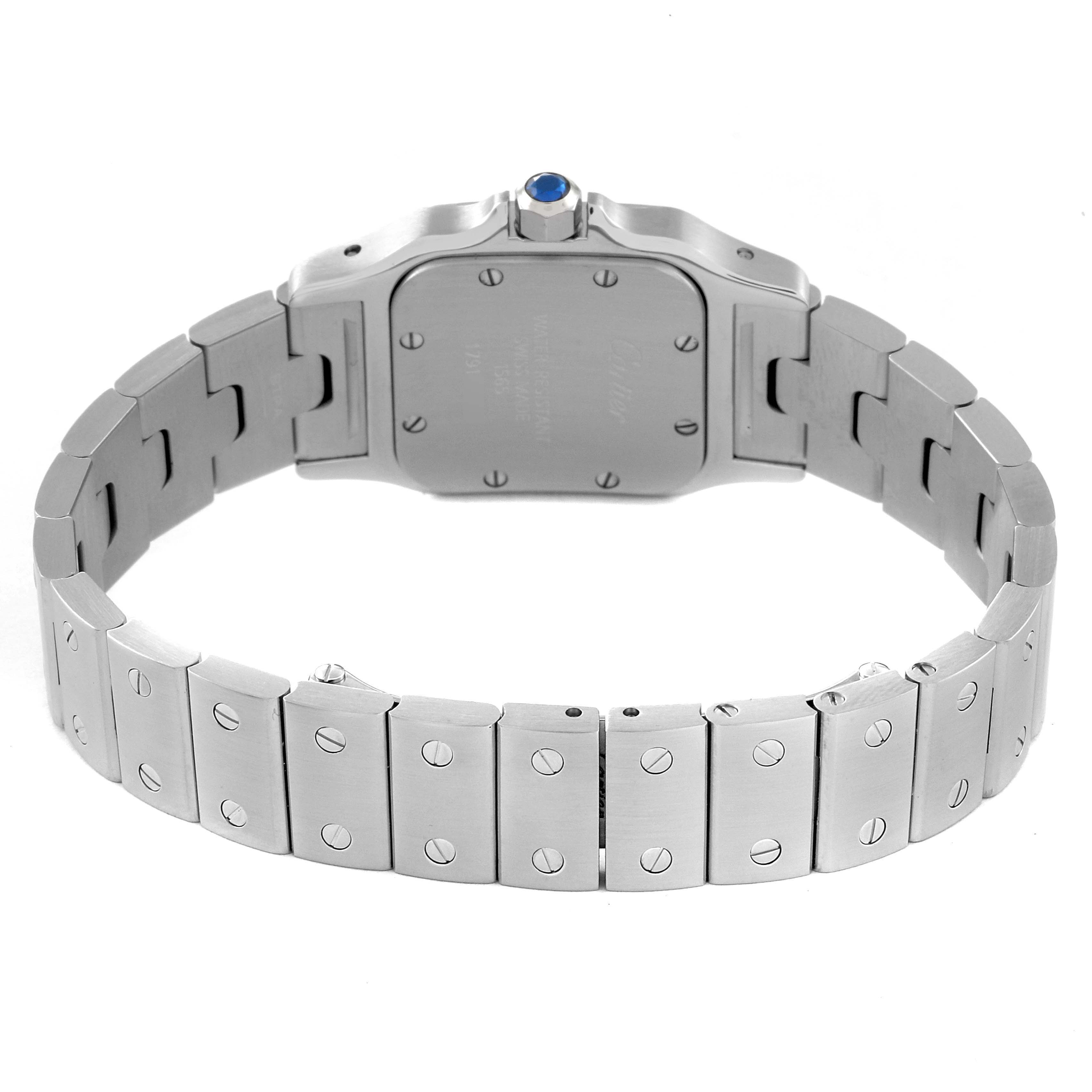 The image shows the back view of a Santos model by Cartier, focusing on the case back and metal bracelet.