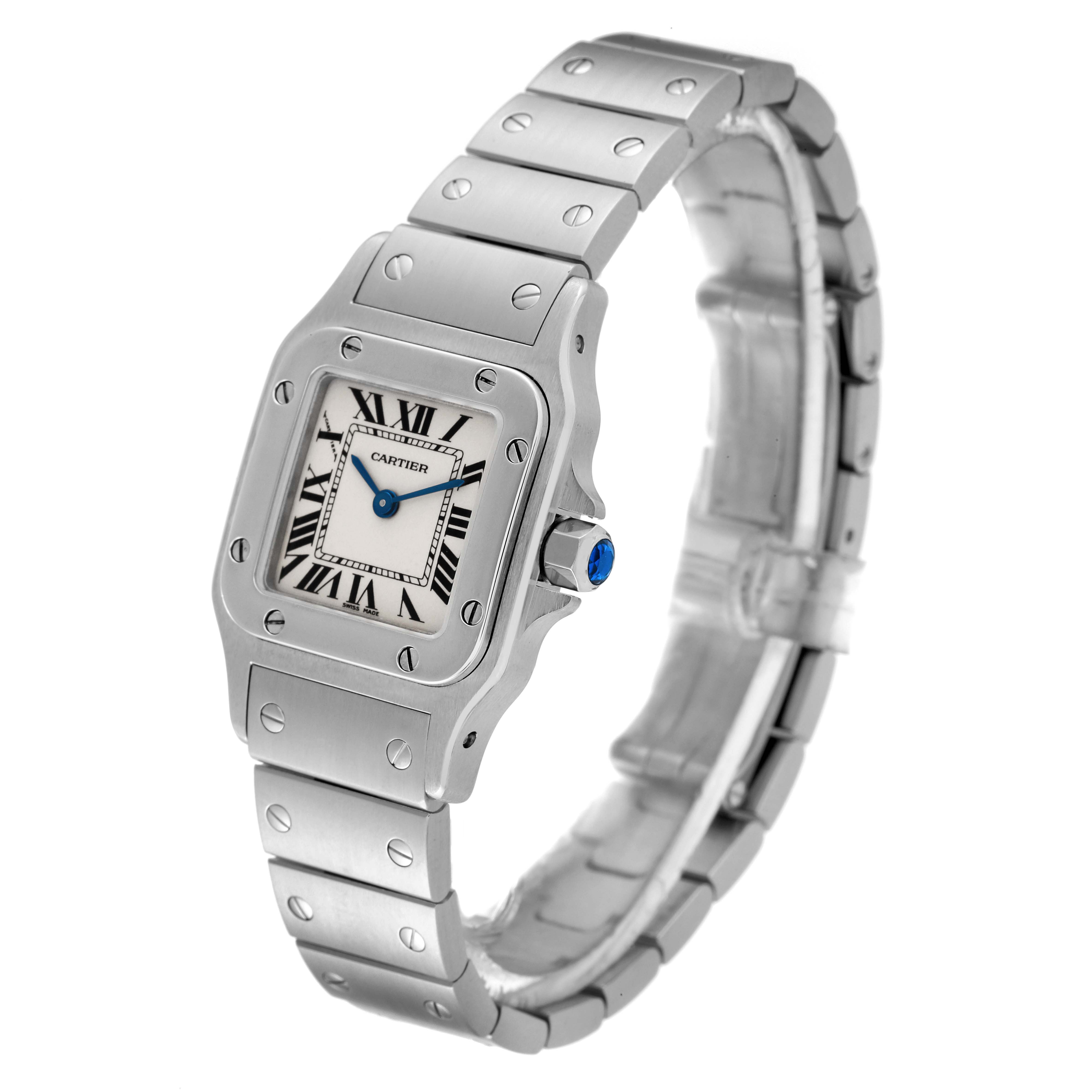 The image shows a Cartier Santos W20056D6 Women's Stainless Steel Silver Dial W20056D6 Women's Stainless Steel Silver Dial watch at a slight angle, highlighting its square face, Roman numerals, metal bracelet, and blue crown.