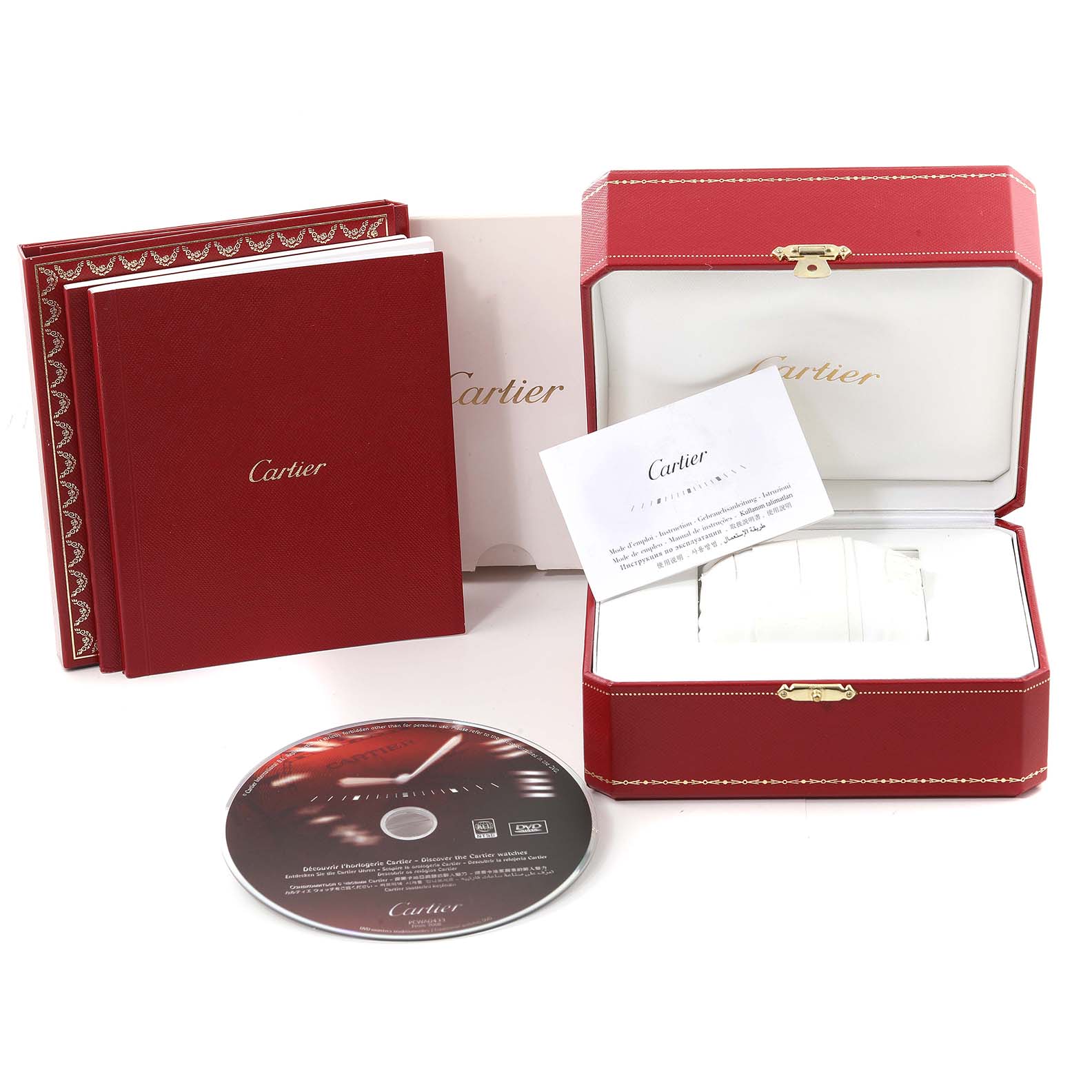 The image shows the packaging, instruction manual, authentication card, and DVD for the Cartier Tank Americaine W2620031 Women's Rose Gold Silver Dial W2620031 Women's Rose Gold Silver Dial watch.