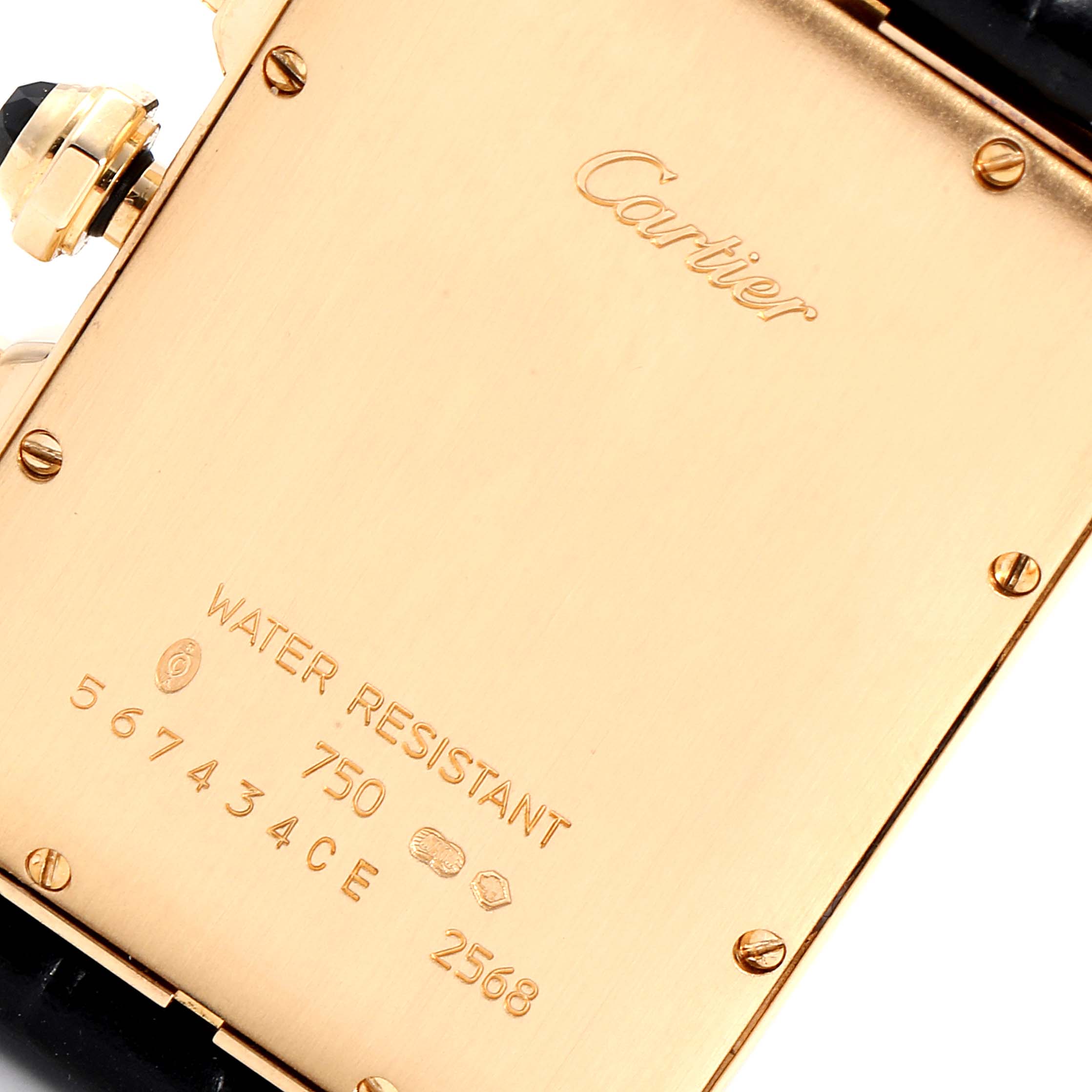 The image shows the back case of a Cartier Tank Americaine 2568 Men
s Yellow Gold Silver Dial 2568 Men
s Yellow Gold Silver Dial watch, including the brand engraving, serial number, and other markings.