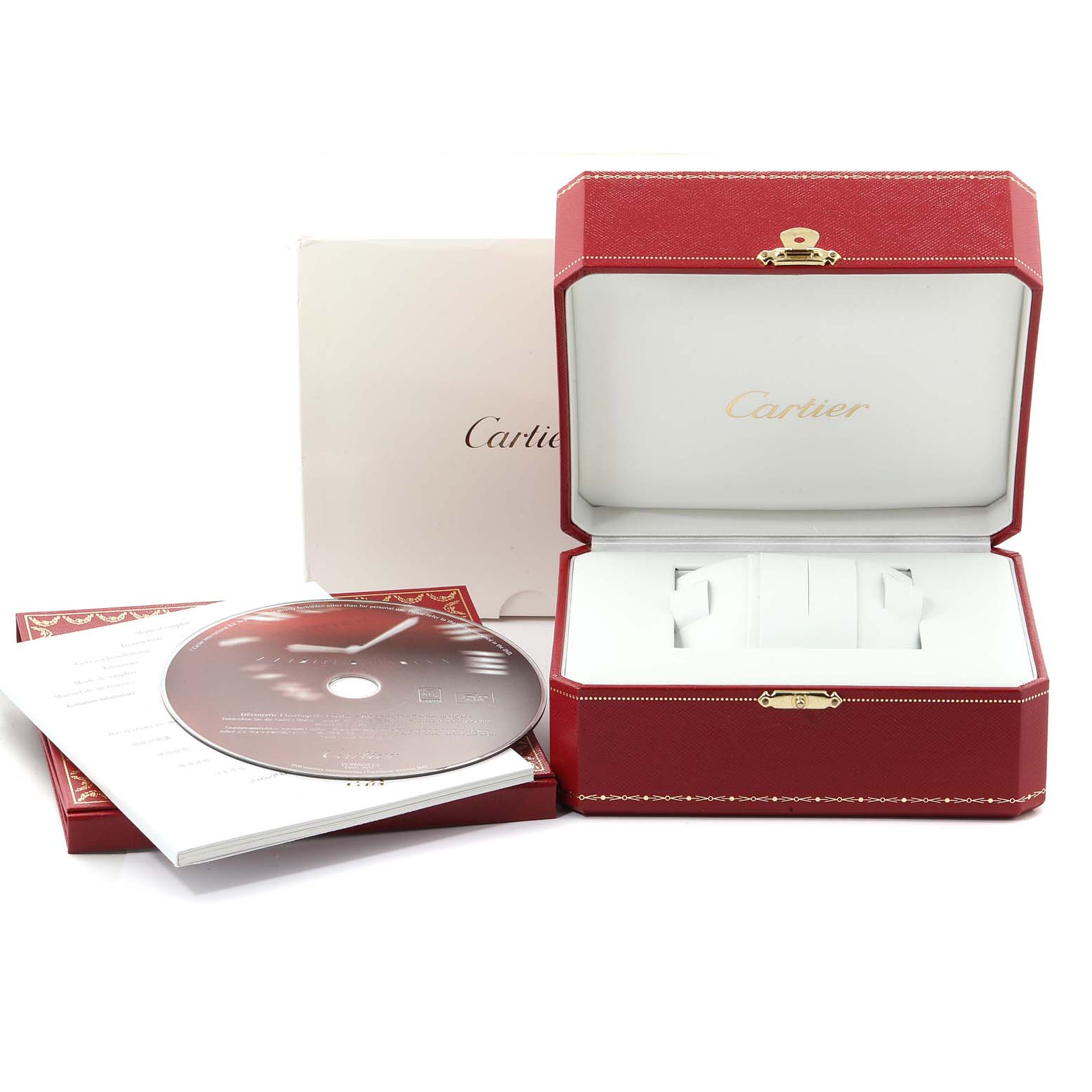 This image shows the packaging and accessories of the Cartier Tank Americaine 2568 Men
s Yellow Gold Silver Dial 2568 Men
s Yellow Gold Silver Dial watch, including the box, a CD, and written materials.