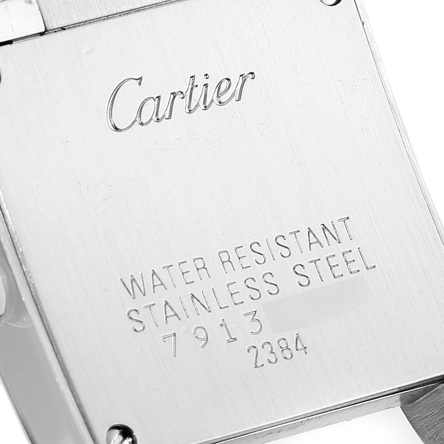 This image shows the back case of the Cartier Tank Francaise W51008Q3 Women
s Stainless Steel Silver Dial W51008Q3 Women
s Stainless Steel Silver Dial watch, featuring engravings of the brand name and specifications.