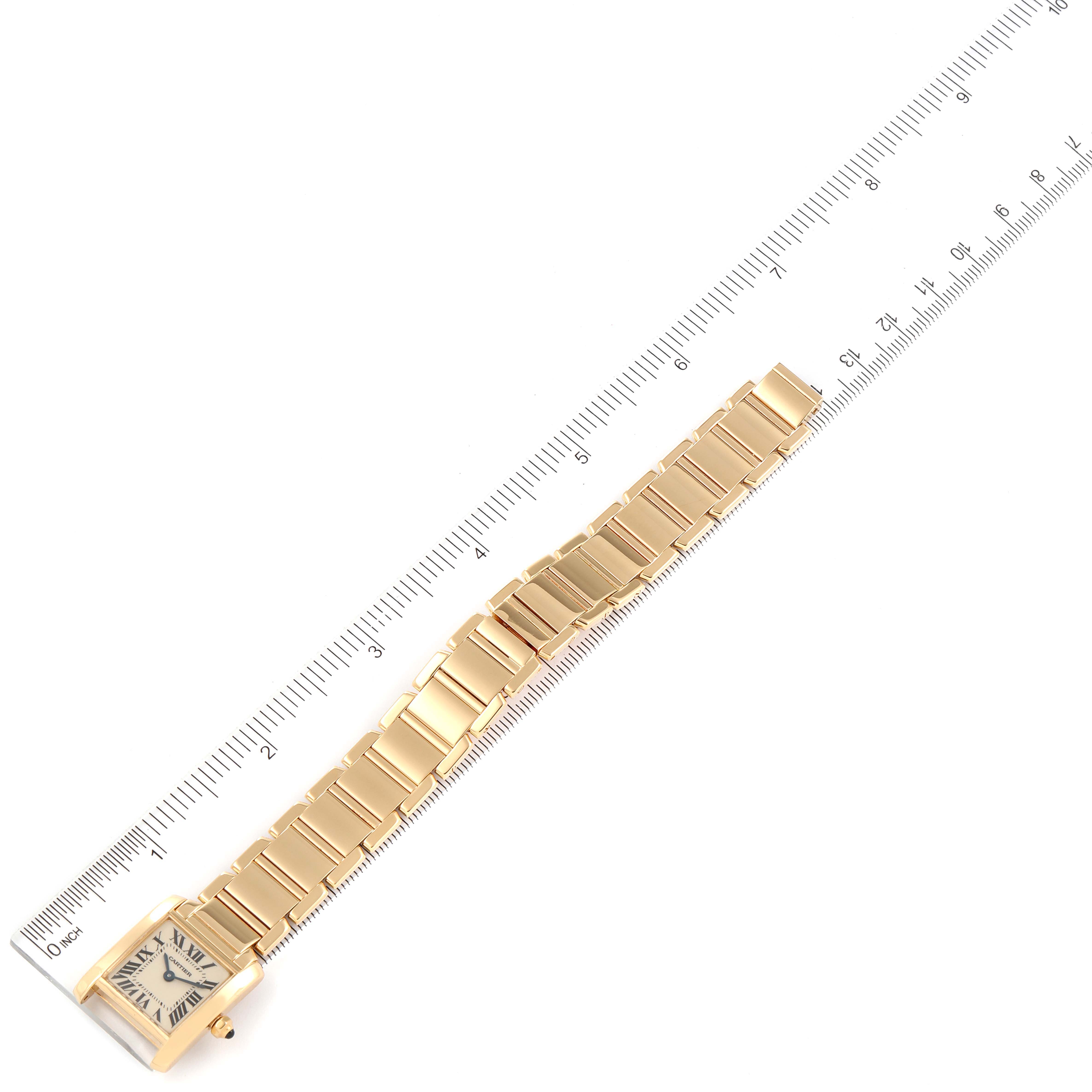 The image shows a Cartier Tank Francaise W50002N2 Women's Yellow Gold Silver Dial W50002N2 Women's Yellow Gold Silver Dial watch laid flat with its full bracelet and a ruler beside it for scale.