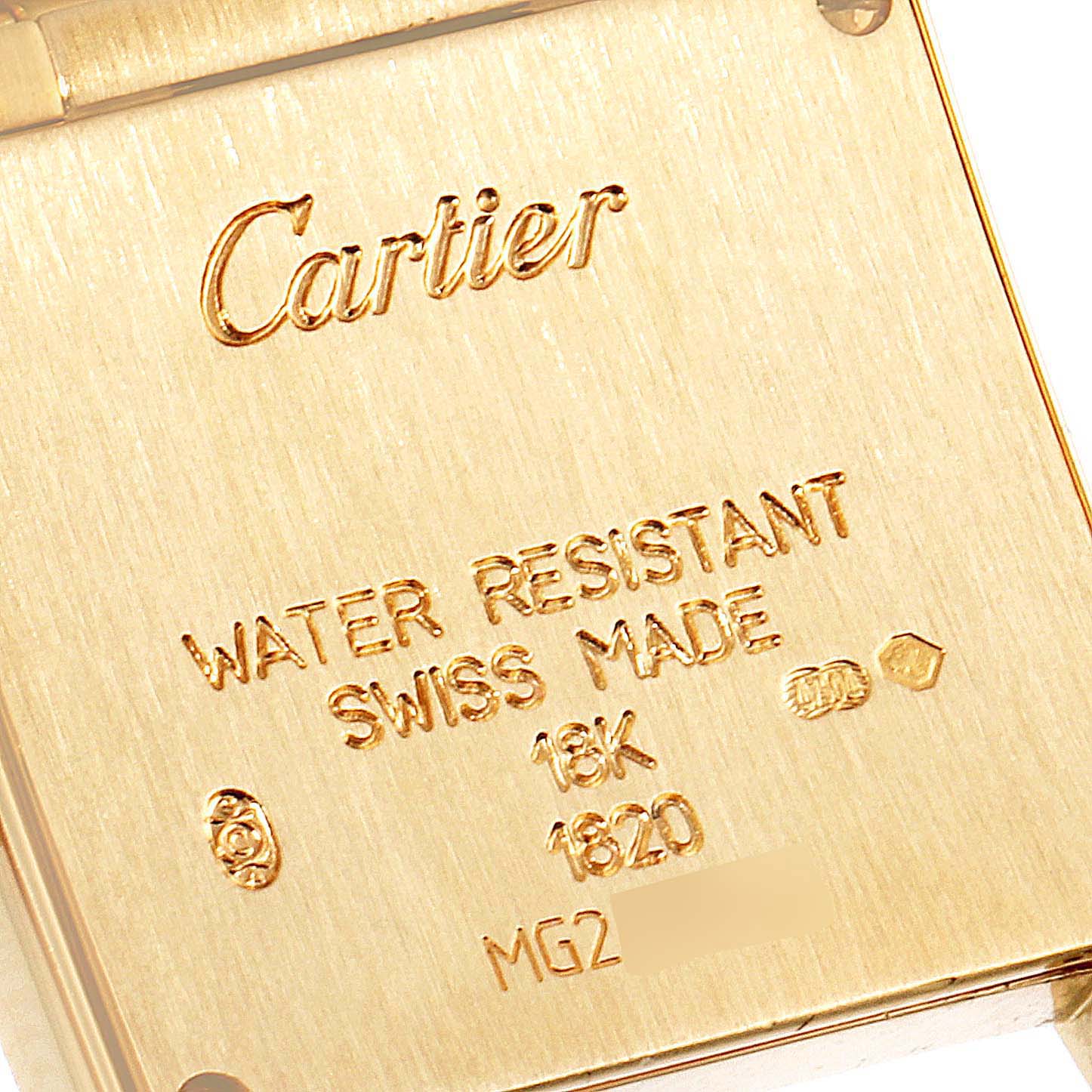 This image shows the back case of a Cartier Tank Française watch, highlighting engraving details.