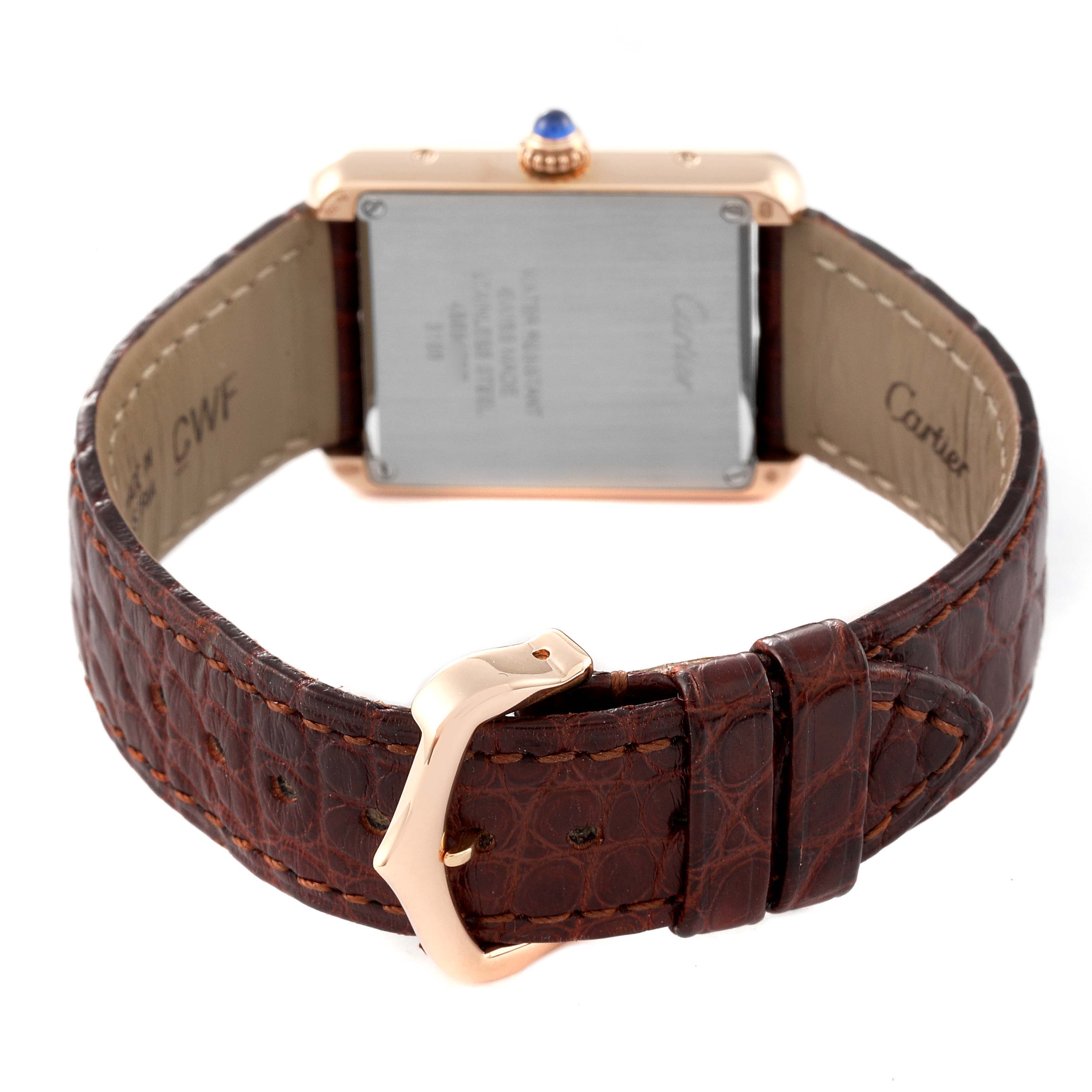 The Tank Solo model by Cartier is shown from the back, highlighting the case's back, brown leather strap, and buckle.