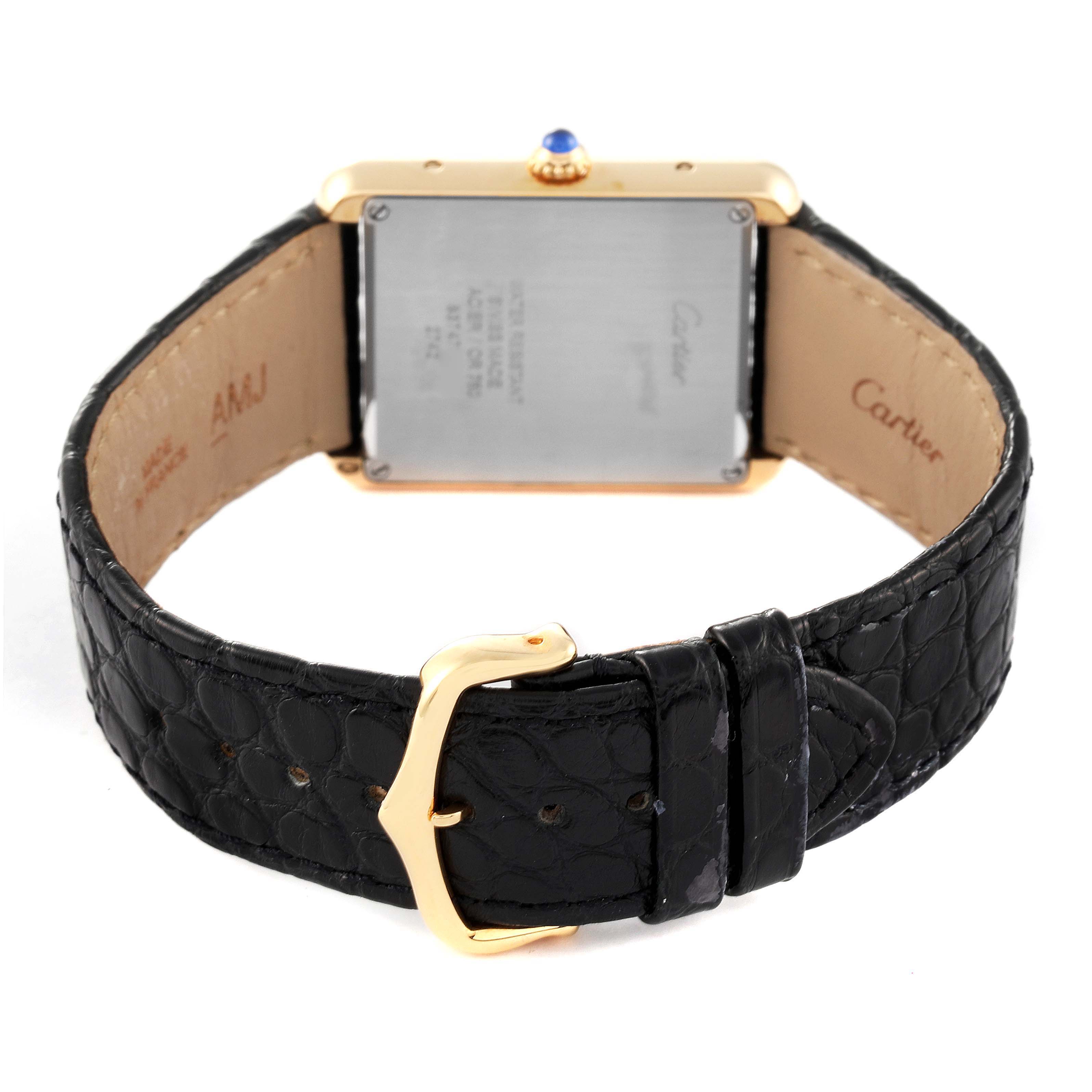 The Cartier Tank Solo W1018855 Men's Yellow Gold Silver Dial W1018855 Men's Yellow Gold Silver Dial watch is shown from the back, displaying its leather strap and buckle.