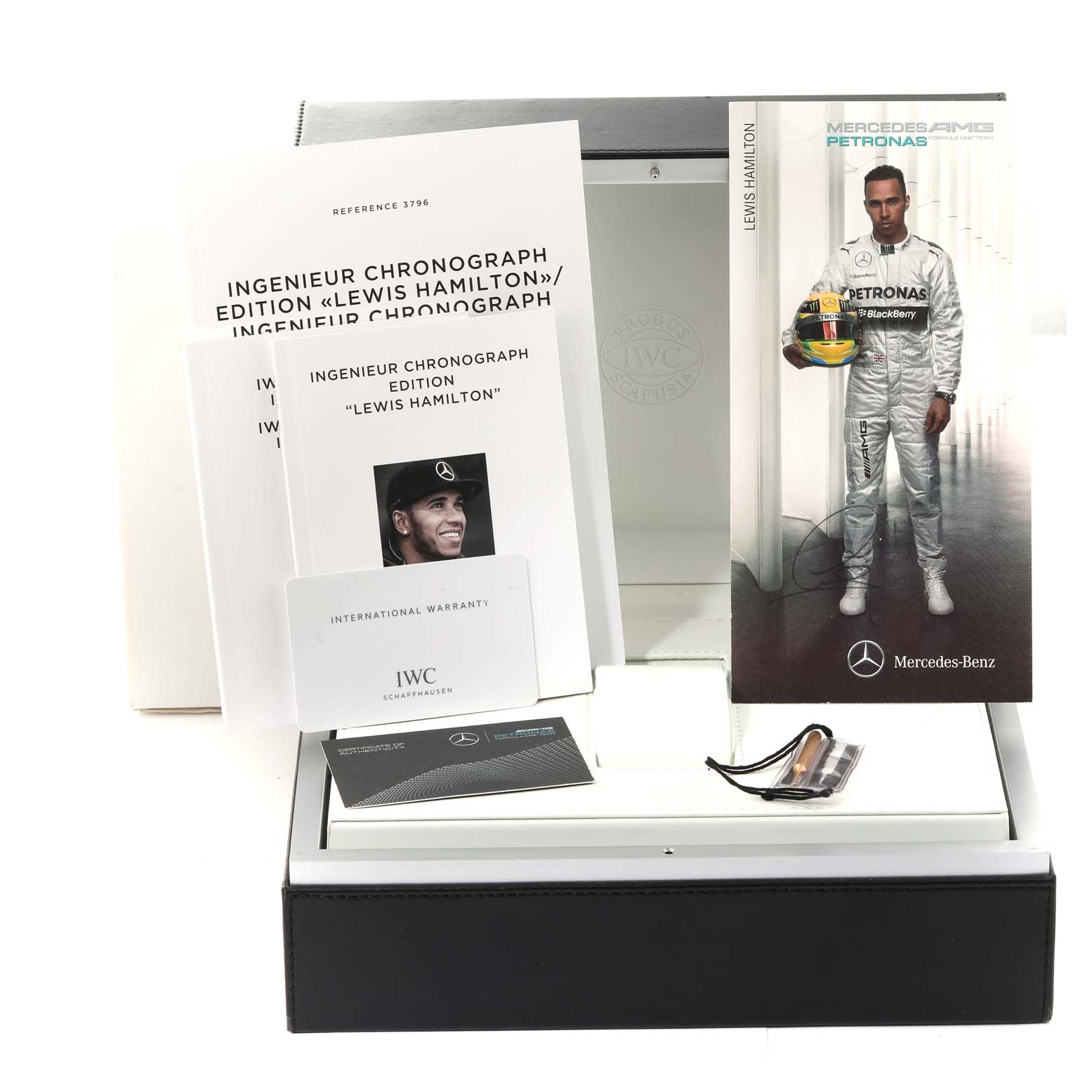 The image shows the packaging, booklets, and warranty card for the IWC Ingenieur IW379602 Men's Titanium Black Dial IW379602 Men's Titanium Black Dial Chronograph Edition Lewis Hamilton.