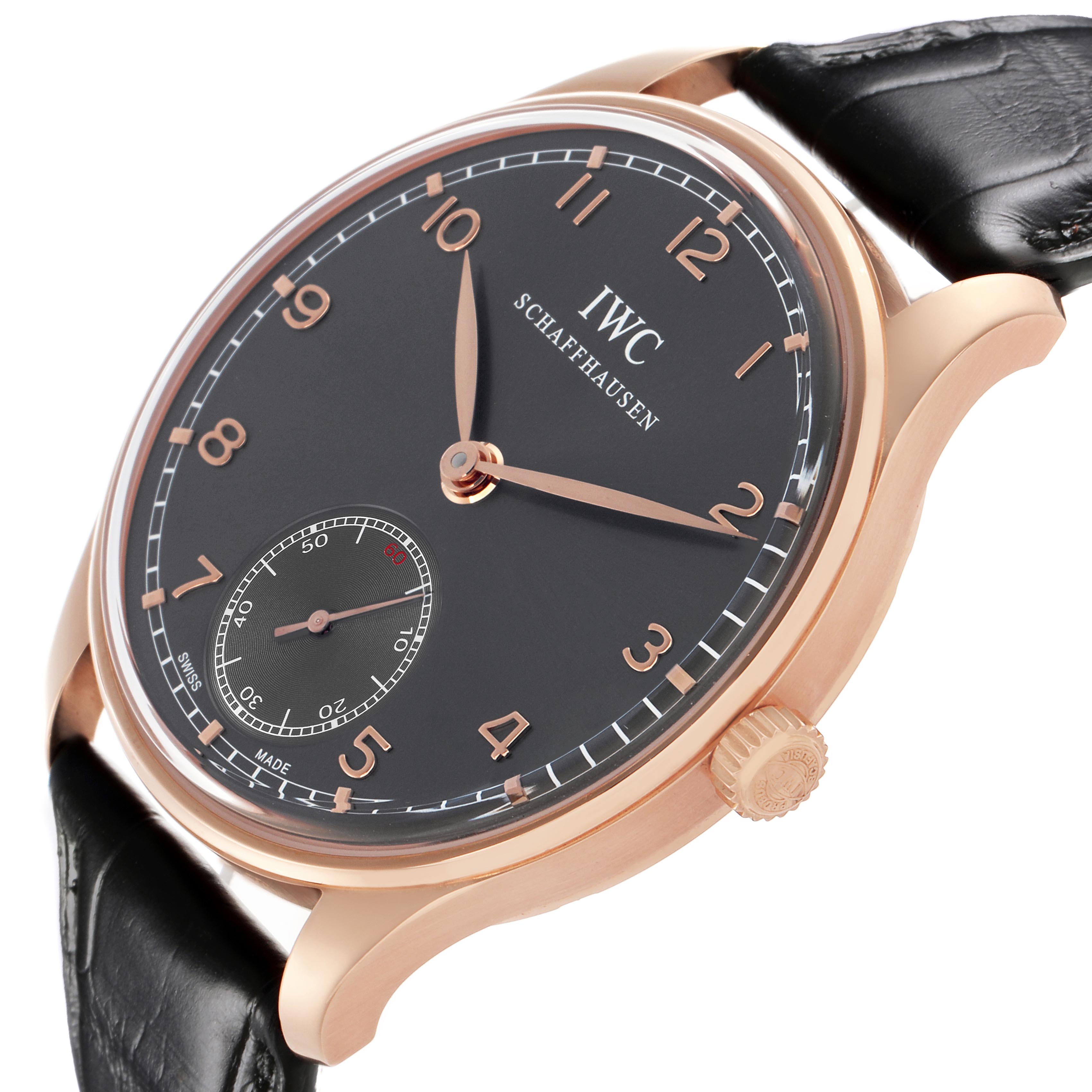 The IWC Portuguese IW545406 Men's Rose Gold Grey Dial IW545406 Men's Rose Gold Grey Dial watch is shown at an angled side view, highlighting its dial, casing, and leather strap.