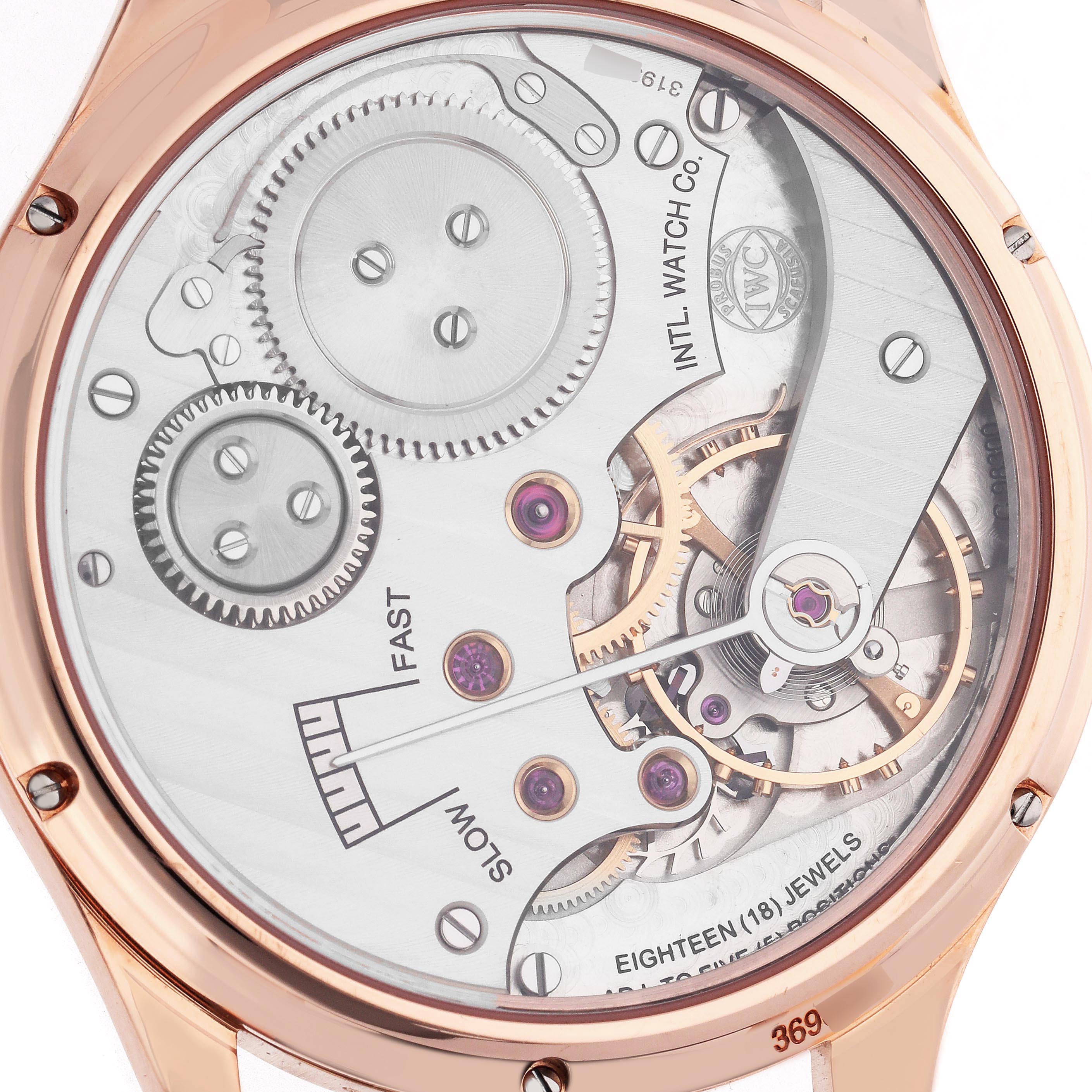 The image shows the back view of the IWC Portuguese IW545406 Men's Rose Gold Grey Dial IW545406 Men's Rose Gold Grey Dial watch, highlighting its intricate mechanical movement and gears.