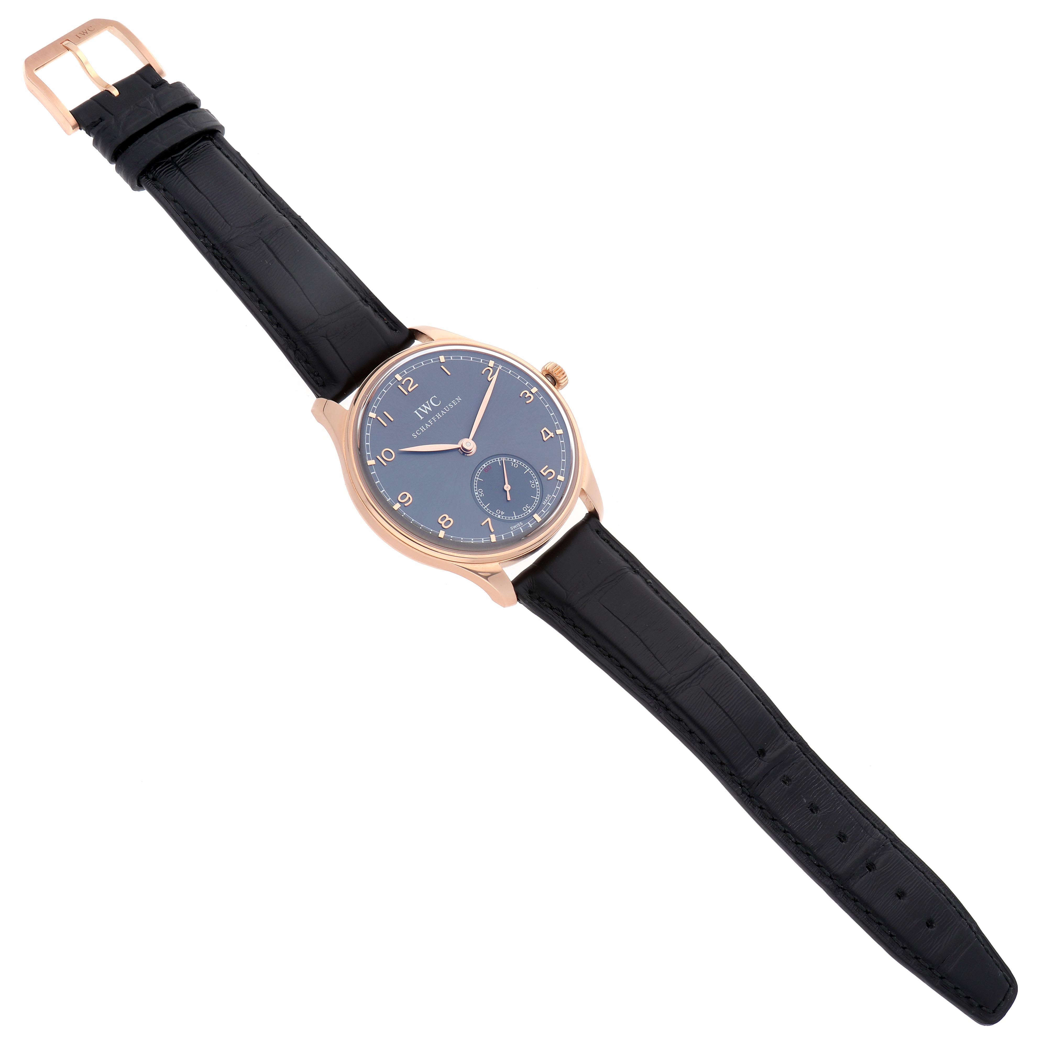 The IWC Portuguese IW545406 Men's Rose Gold Grey Dial IW545406 Men's Rose Gold Grey Dial model watch is shown at an overhead angle, displaying the face, strap, buckle, and crown.