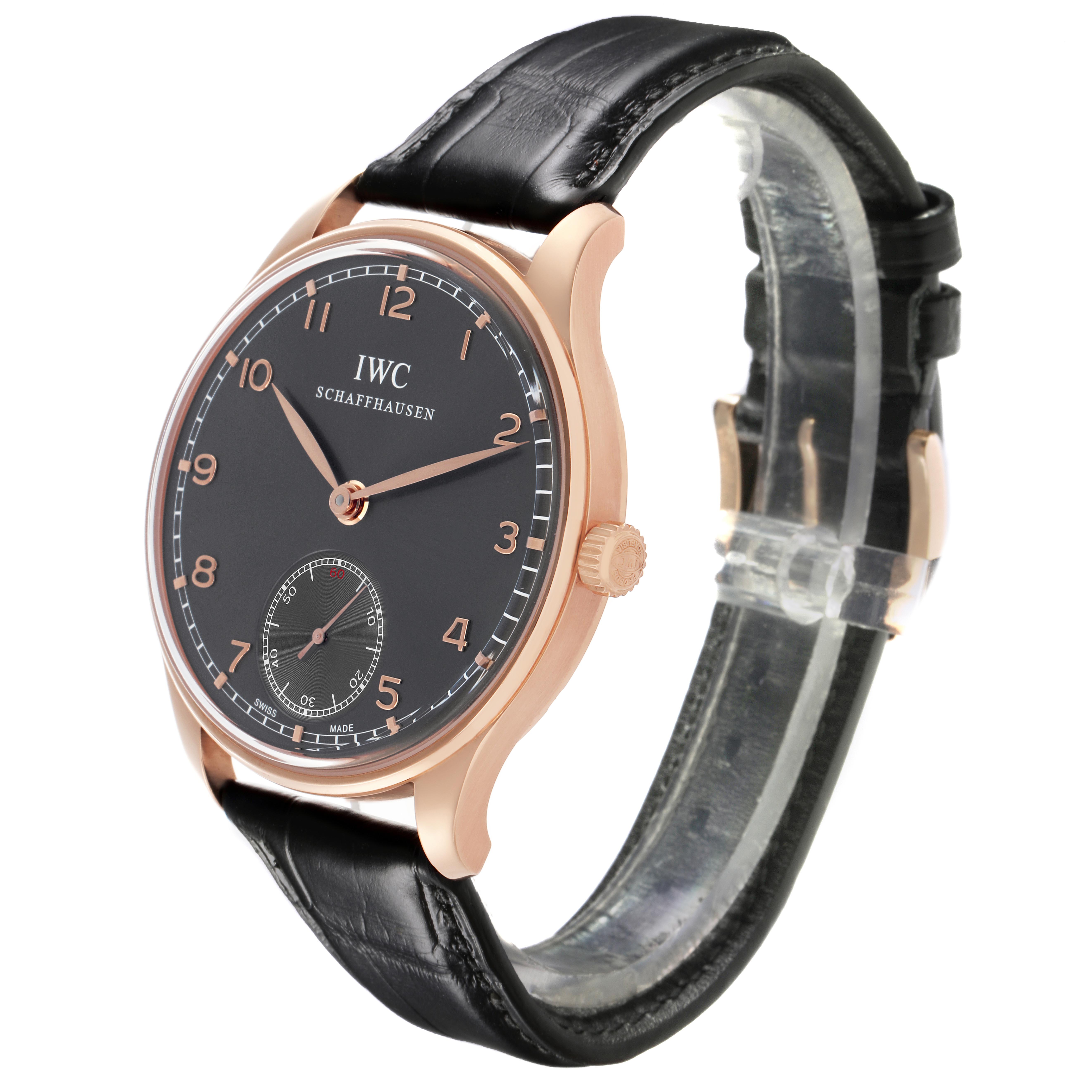 The IWC Portuguese IW545406 Men's Rose Gold Grey Dial IW545406 Men's Rose Gold Grey Dial watch is shown from a three-quarter angle highlighting the face, case, crown, and black leather strap.
