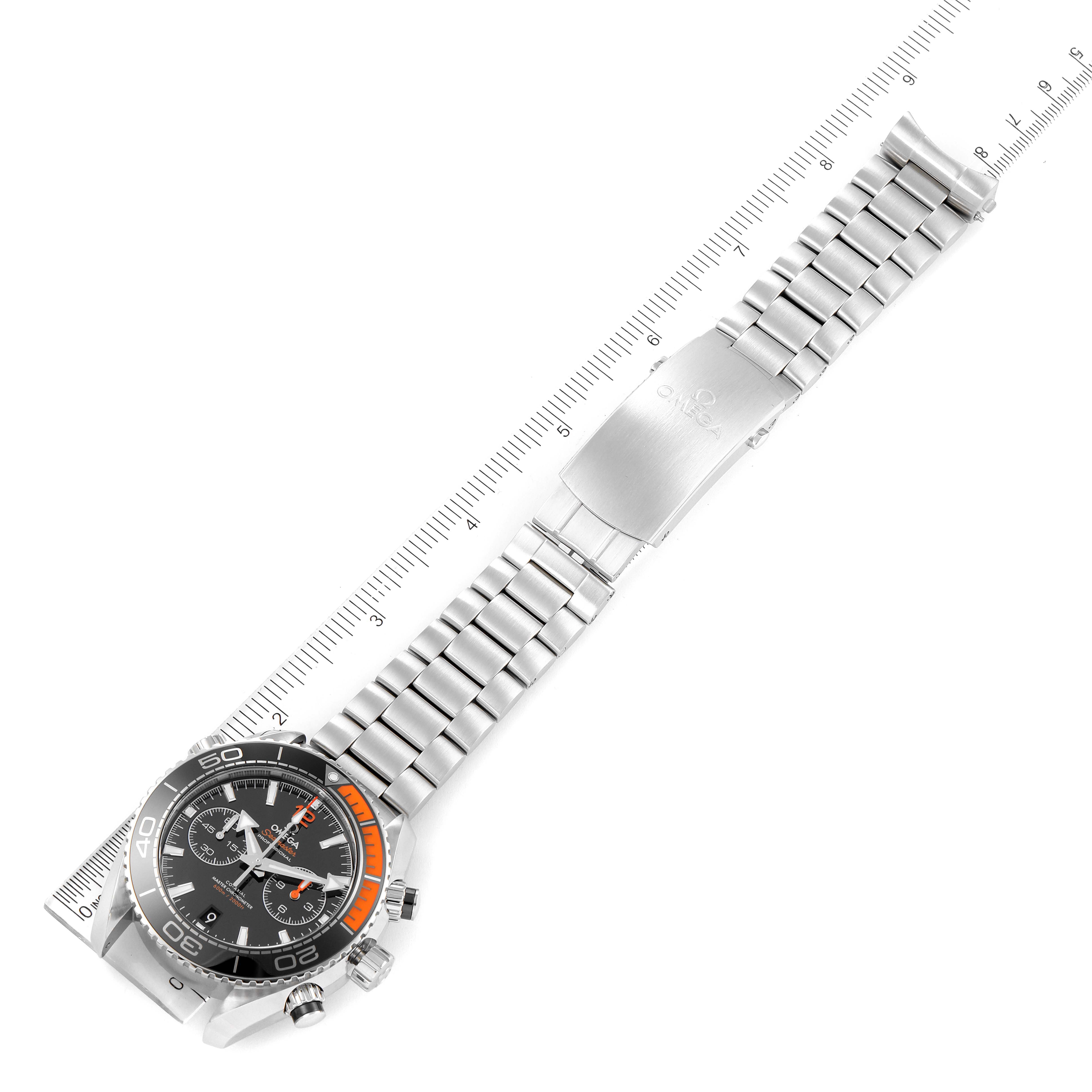 The image shows an Omega Planet Ocean 215.30.46.51.01.002 Men
s Stainless Steel Black Dial 215.30.46.51.01.002 Men
s Stainless Steel Black Dial watch laid flat with a ruler beside it, displaying the bracelet and watch face clearly.